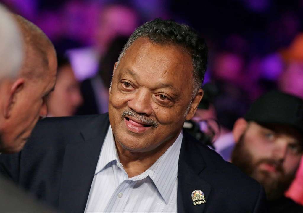 Rev. Jesse Jackson joins the crowd before the start of the world welterweight championship bout between Floyd Mayweather Jr., and Manny Pacquiao in Las Vegas on May 2, 2015. (AP Photo/Isaac Brekken, File)