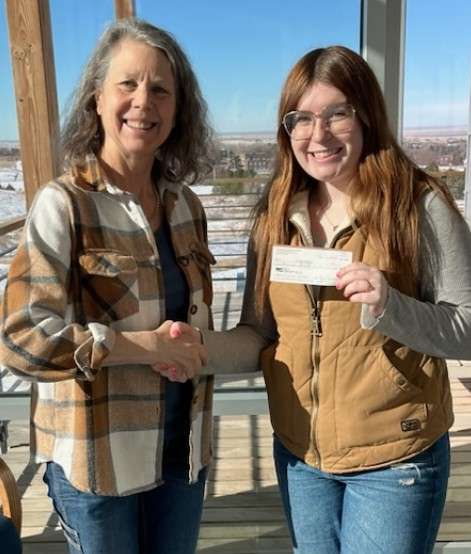 District Conservationist Robin Foulk, left, presents a $1,000 scholarship to Gracie Ackles of Farwell, Neb., Jan 24, 2025, in the CSC Rangeland building. Ackles received a second $1,000 scholarship in 2026. (Courtesy photo, used with permission)