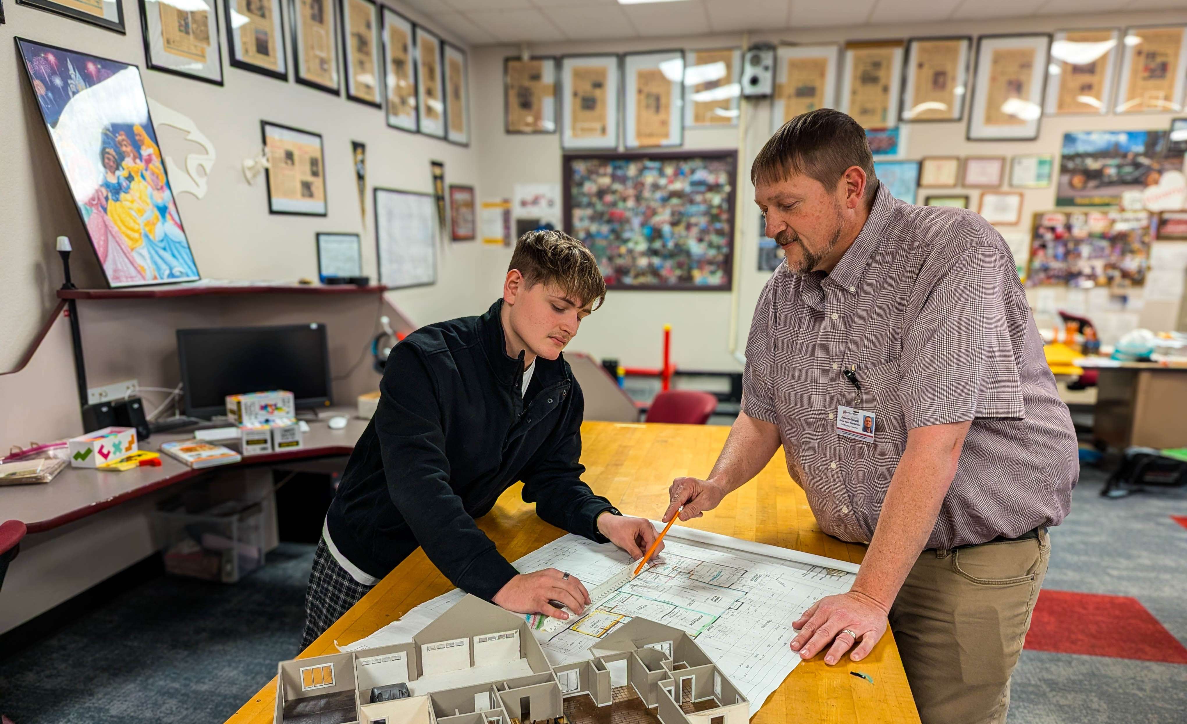 From paper to reality—Slayde Apley (left) and instructor Jake Hofflinger discuss the fine details of blueprint reading in the GBHS workshop.