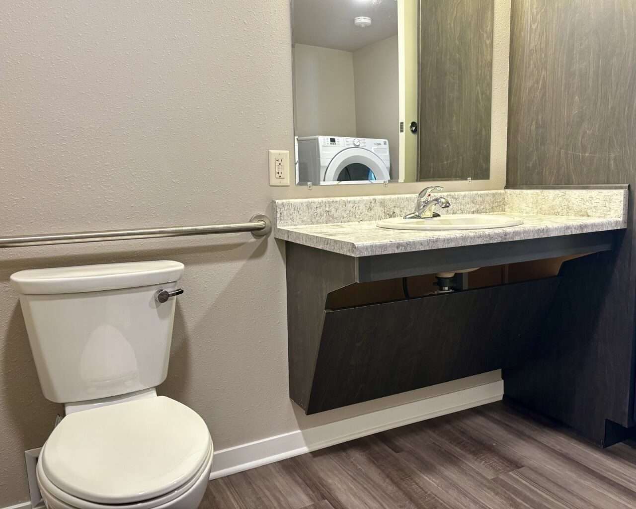 The bathroom of an ADA-compliant unit at&nbsp;Flintwood Senior Housing in Russell. Washers and dryers are located in the bathrooms of all units. Photo by Tony Guerrero/Hays Post