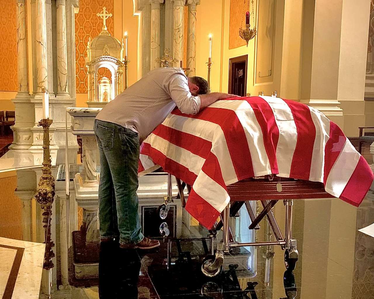 Chase Kear with Fr. Emil Kapaun at the Cathedral of the Immaculate Conception in Wichita after his remains were returned to Kansas. Courtesy photo