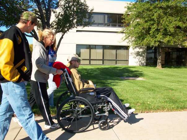 Chase Kear being pushed in a wheelchair after surviving his pole vaulting accident. Courtesy photo