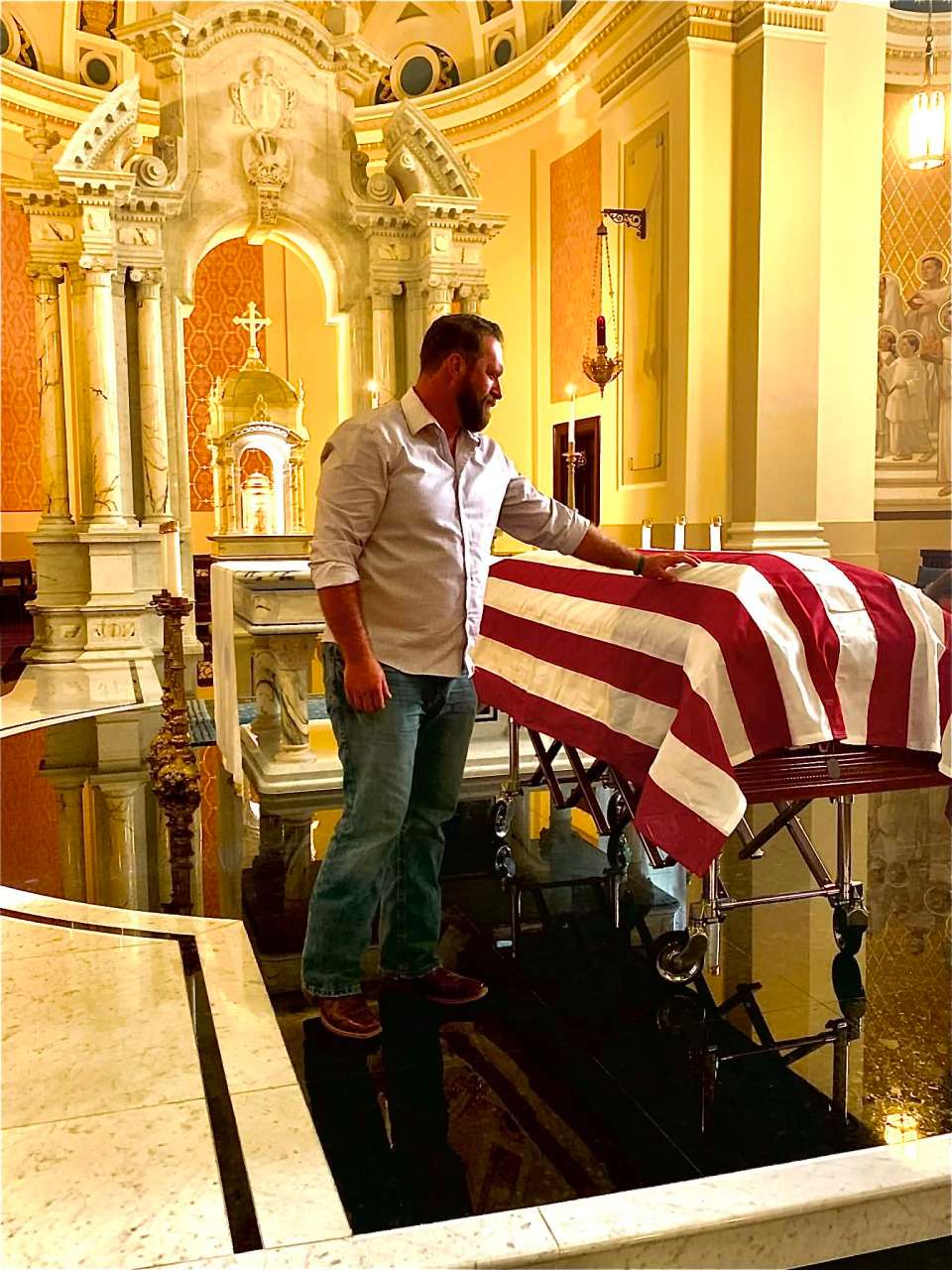 When Fr. Emil Kapaun's remains arrived at the Cathedral of the Immaculate Conception in Wichita, 24-hour guards were needed to watch over his casket. Chase Kear left work to do so. Courtesy photo