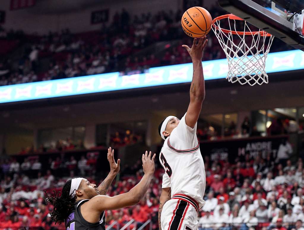 Texas Tech forward Lejuan Watts (3) drives to the basket ahead of Kansas State guard Mobi Ikegwuruka during the first half in an NCAA college basketball game, Saturday, Feb. 21, 2026, in Lubbock, Texas. (AP Photo/Annie Rice)