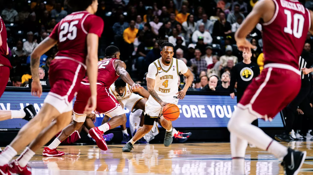 T.J. Williams brings the ball up the court against a Temple defender. (Courtesy Wichita State Athletic Communications)
