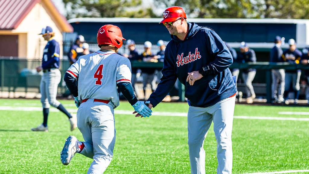 Blue Dragon head baseball coach Brock Nehls high-fives sophomre Eli Duncan (4) after a home run in the doubleheader series sweep over Highland Community College Monday, Feb. 23, 2026 at Hobart-Detter Field. (Sydney Holzrichter/Blue Dragon Sports Information)
