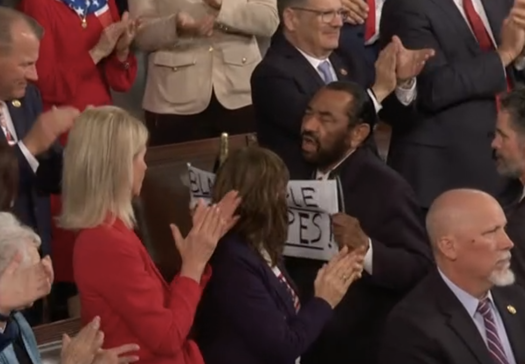 -The House Sergeant at Arms approached and escorted Texas Congressman Al Green, who stood as Trump began speaking with a sign reading “Black People Aren’t Apes!” from the chamber barely two minutes into the address.&nbsp;Two Trump allies, Rep. Troy Nehls of Texas and Sen. Markwayne Mullin of Oklahoma, had approached the area where Green was sitting before Capitol Police escorted him out.-image courtesy CSPAN