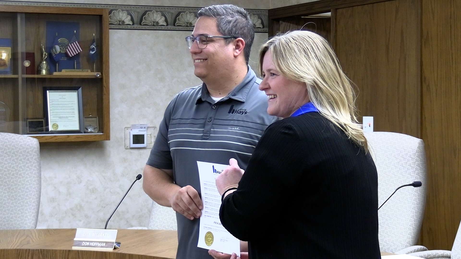 Mayor Mason Ruder and Holly Dickman, water conservation specialist, with the official declaration of "Fix a Leak Week" in Hays as the third week of March. Photo by Becky Kiser/Hays Post