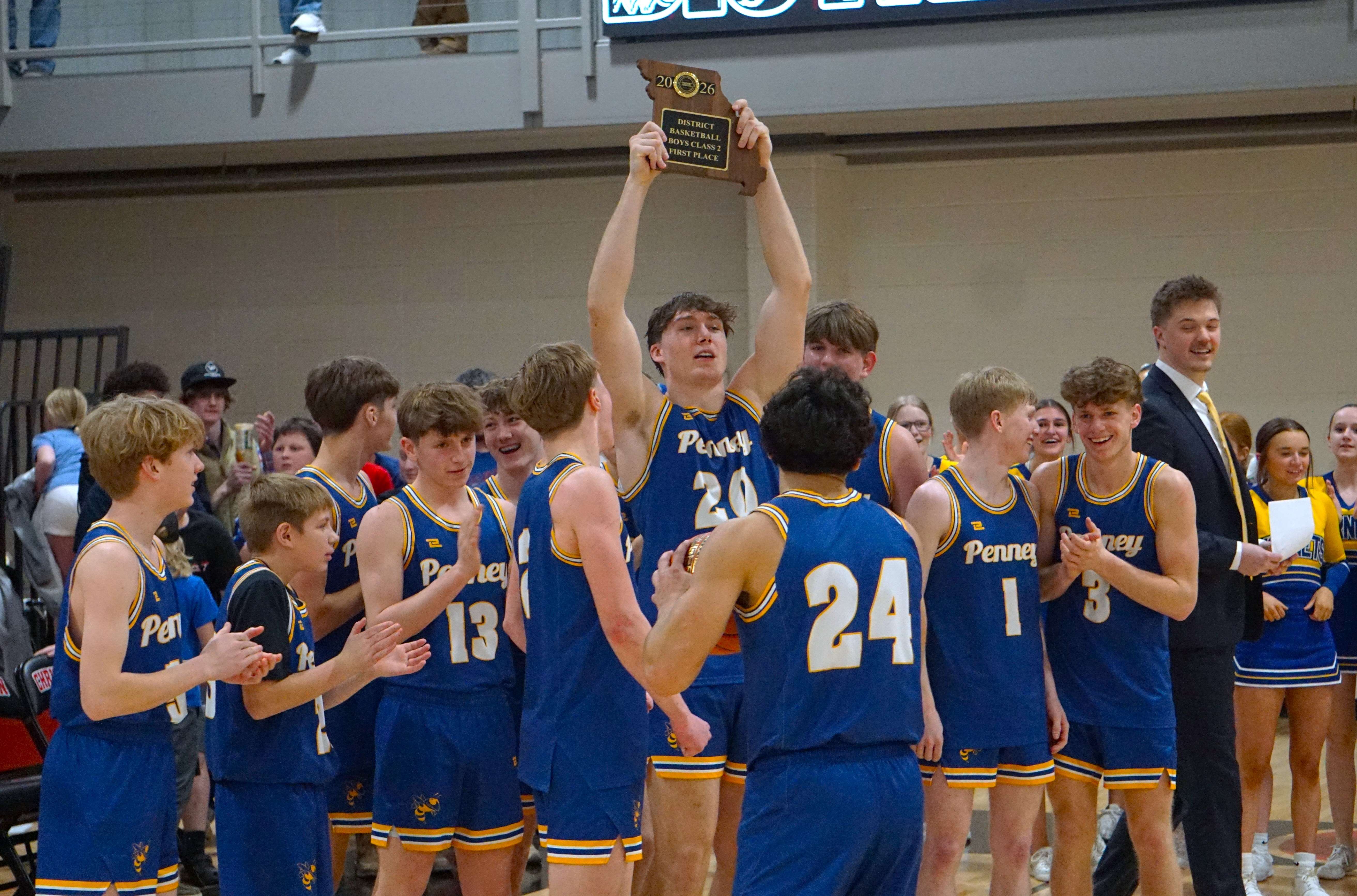 Jacob Miller hoists the trophy as the Penney Hornets won their first Class 1 District 16 title since 2016/ Photo by Matt Pike