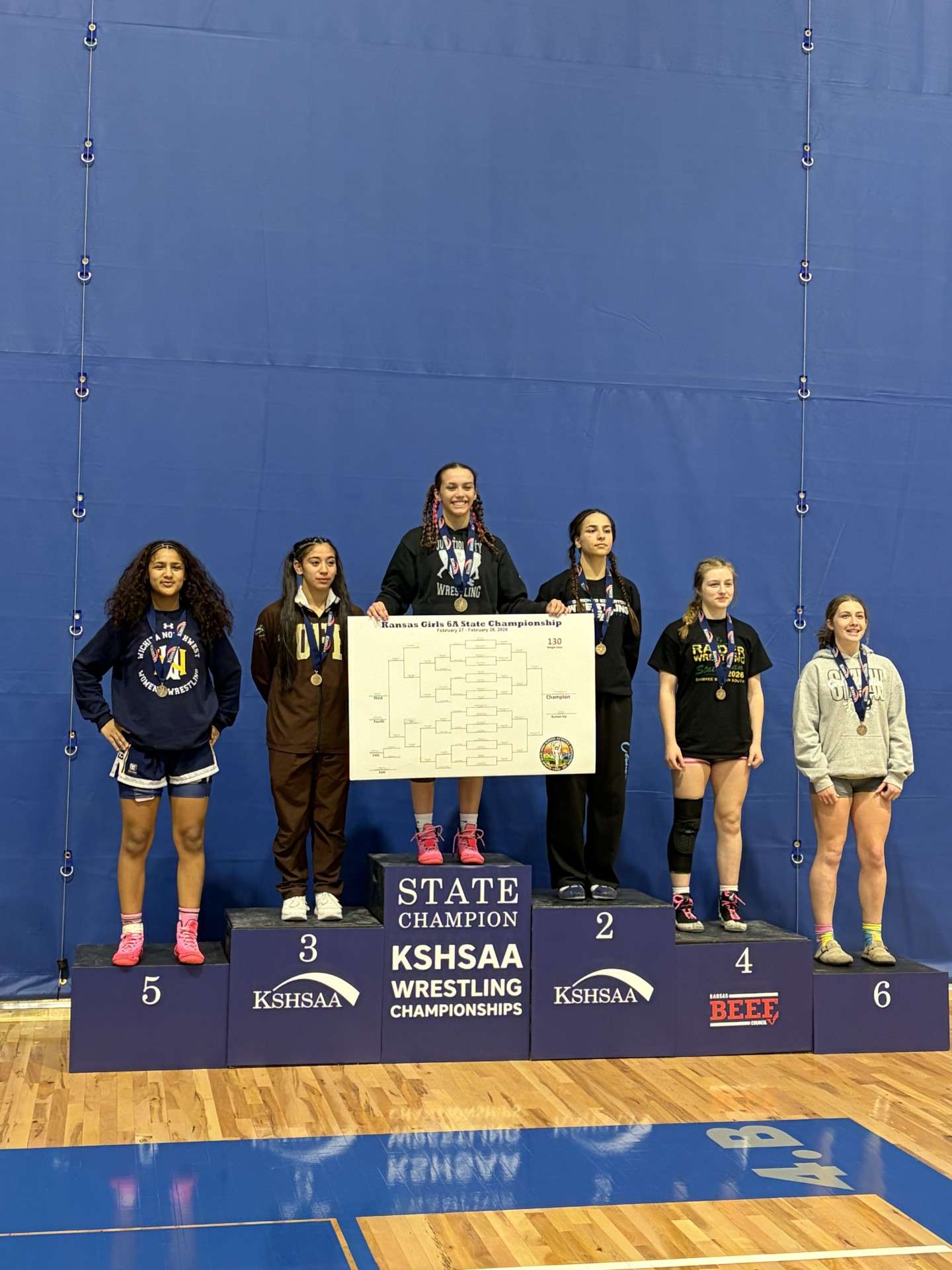 Junction City junior Elizabeth Edgerton-Diaz&nbsp;stands at the top of the podium as the State Champion for 130 lbs. in class 6A girls wrestling.