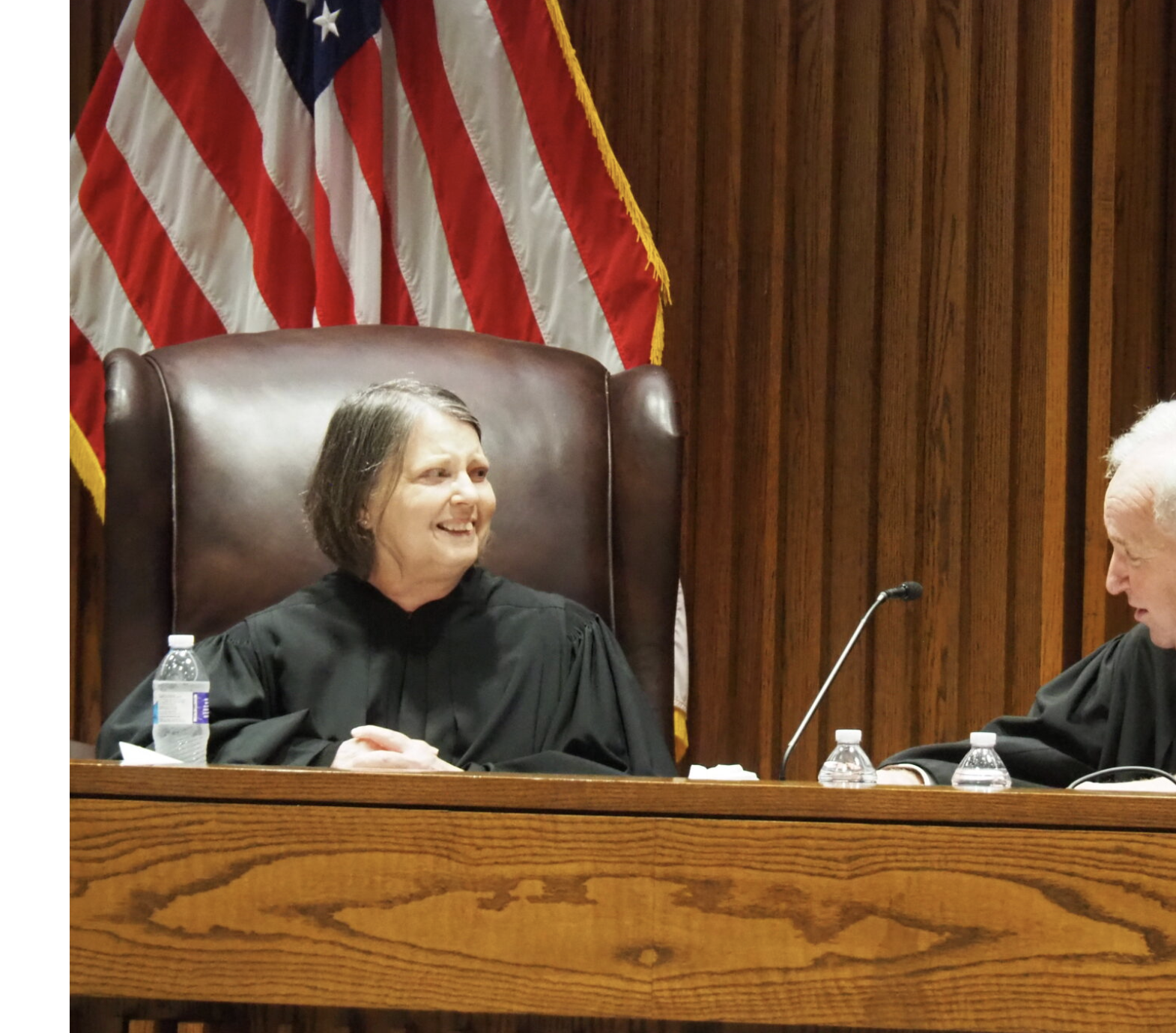  Kansas Supreme Court Justice Marla Luckert, left, suffered a stroke in October, leading to her impending retirement in March. She appears with Chief Justice Eric Rosen, who replaced her as chief justice at a swearing in ceremony on Jan. 8, 2026, at the Kansas Supreme Court building in Topeka. (Photo by Tim Carpenter/Kansas Reflector)
