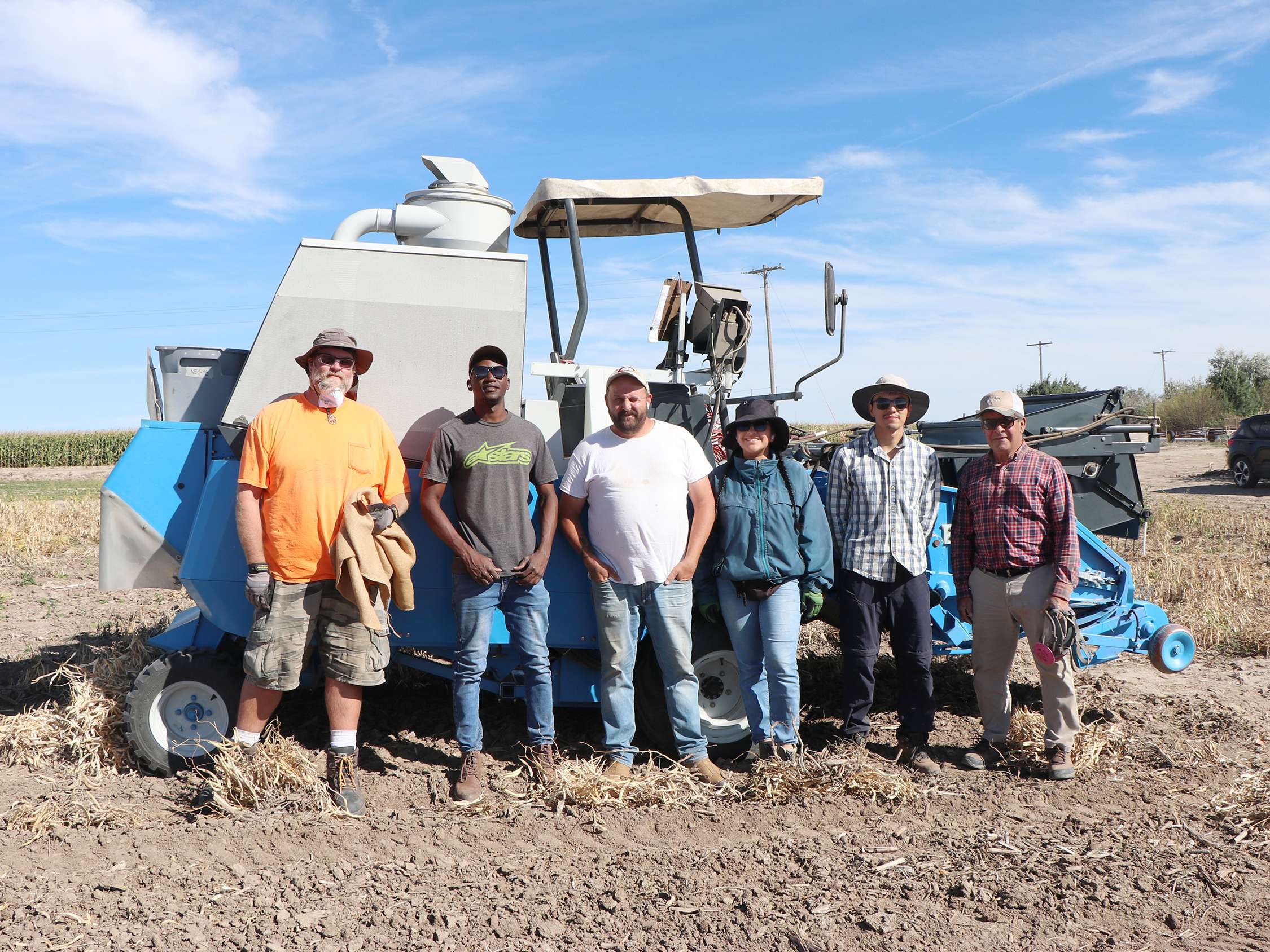 Taking a harvest break in the dry bean field at the Mitchell Ag Lab, from left, Cody Kaarstad, research tech I; Esau Higenyi, intern; Stephen Hespe; Valeska Fuentes-Sepúlveda, intern; Joel Guananga, intern, and Carlos Urrea, Nebraska Extension dry bean breeder. The team harvested 144 varieties replicated four times. Photo by Chabella Guzman