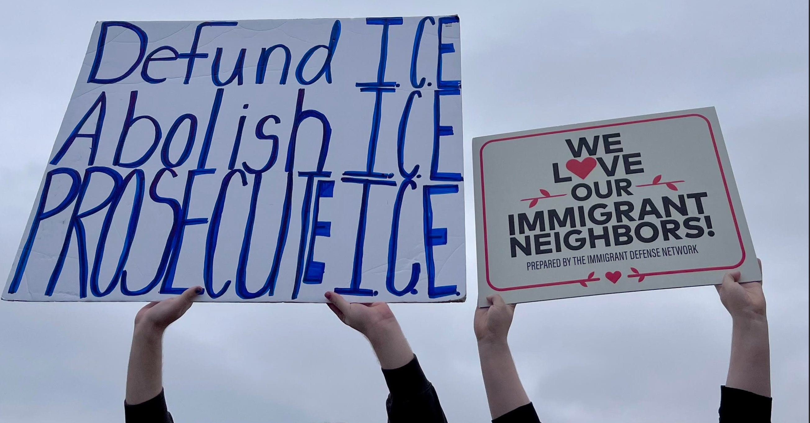 Two Salina Central students holding up signs during protest outside school grounds on March 4, 2026. Photo by Nicolas Fierro