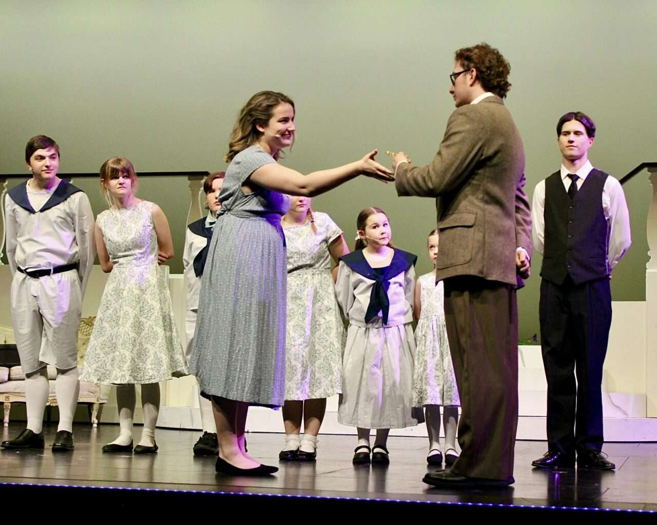 Georg von Trapp handing Maria Rainer a whistle as the von Trapp children watch on. Photo by Tony Guerrero/Hays Post