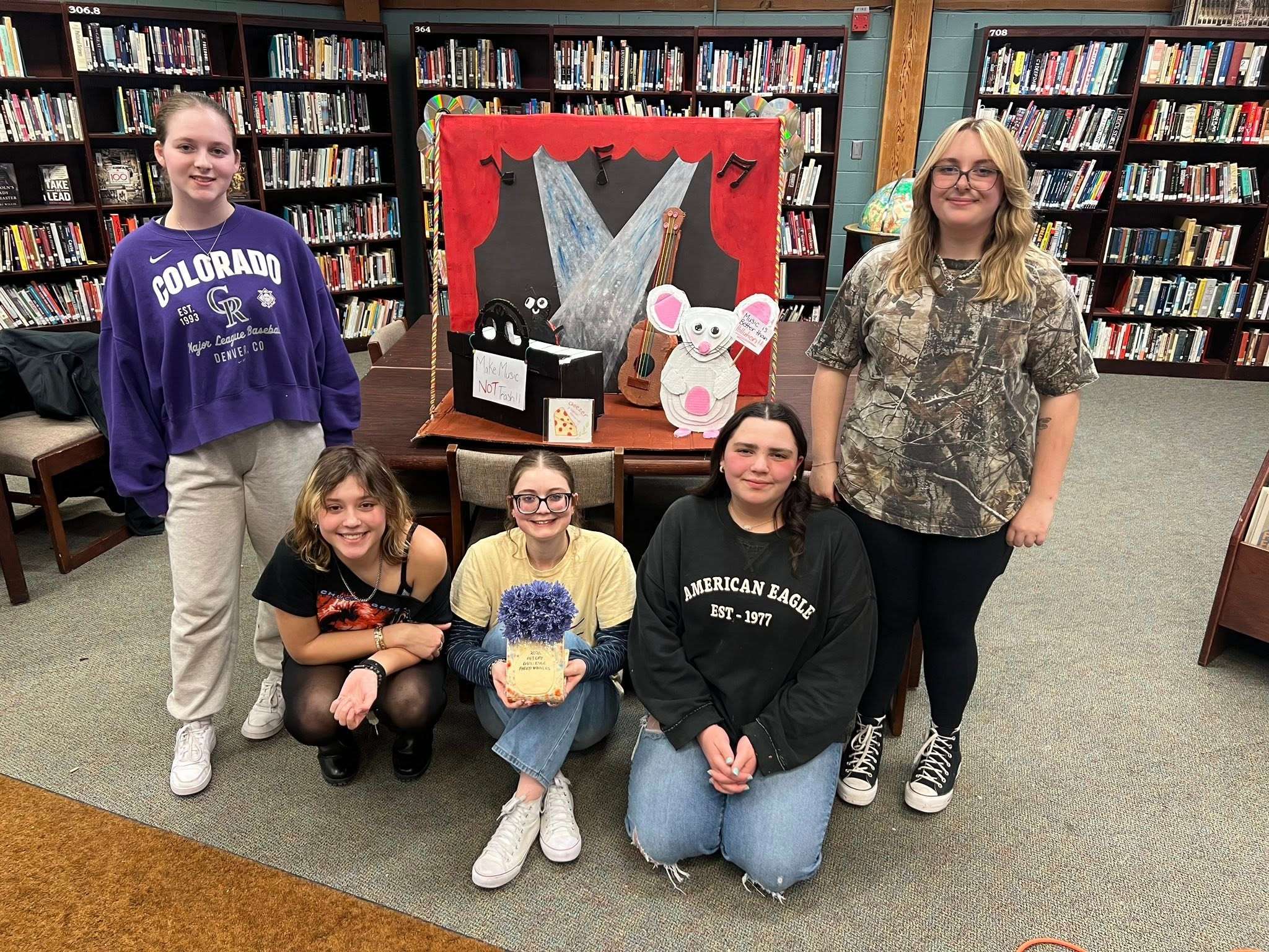 The AHS team poses with their first-place sculpture, made out of material from the KAB recycling center.