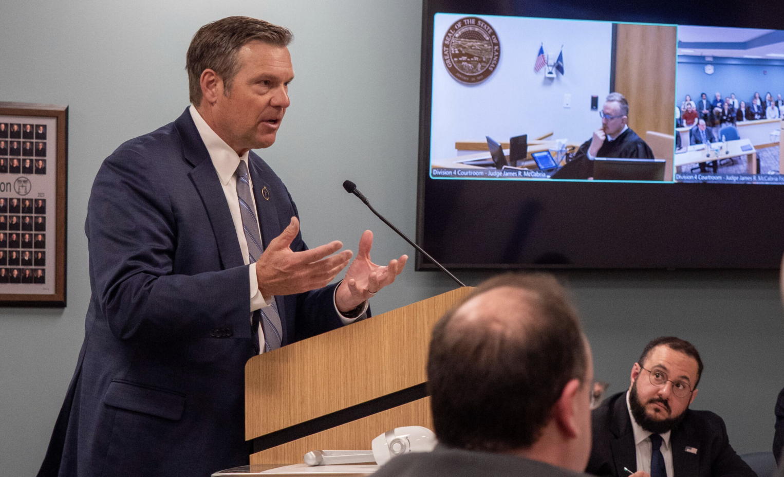 Kansas Attorney General Kris Kobach argues against a restraining order before a Douglas County District Court judge on March 6, 2026. The case was filed by two men opposed to Kansas’ new law forcing transgender people to use their biological sex at birth when using the restroom or on state documents. (Photo by Sherman Smith/Kansas Reflector)