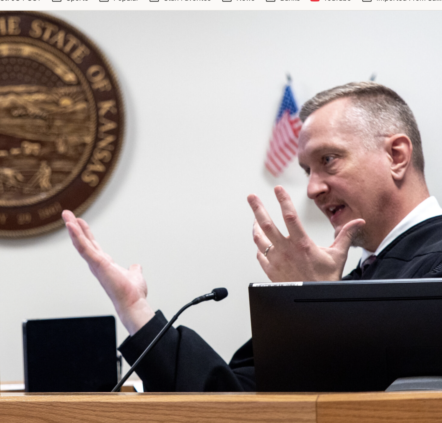  Douglas County District Judge James McCabria talks with attorneys during a hearing on Kansas’ new law that restricts transgender individuals to using their biological sex at birth on documents and when they use restrooms in government office buildings. March 6, 2026 (Photo by Sherman Smith/Kansas Reflector)