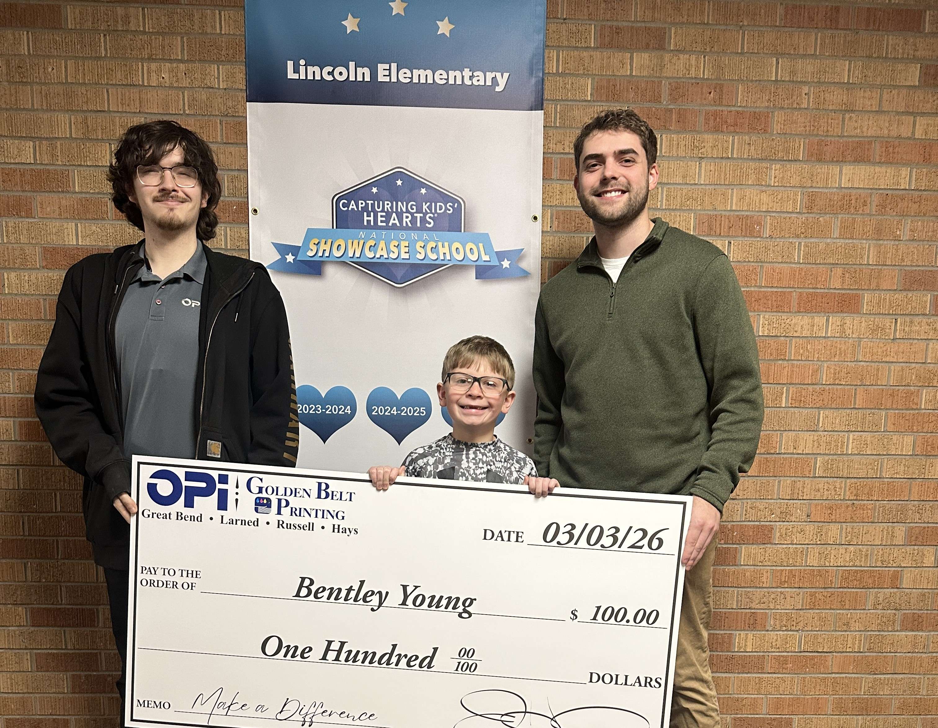 Bentley Young, a second grader at Lincoln Elementary in Great Bend, was presented a giant $100 check from OPI &amp; Golden Belt Printing as a weekly winner in Eagle Media's Make a Difference Contest.