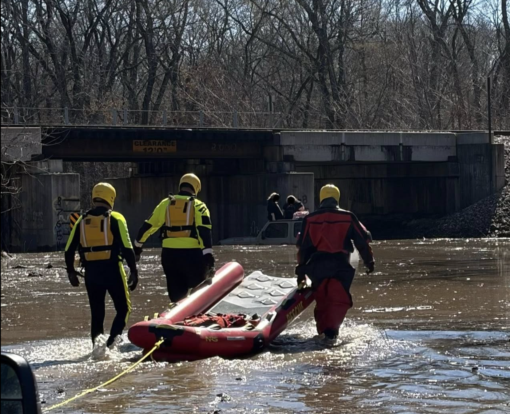2 adults, child rescued after driver stuck on flooded Kansas road