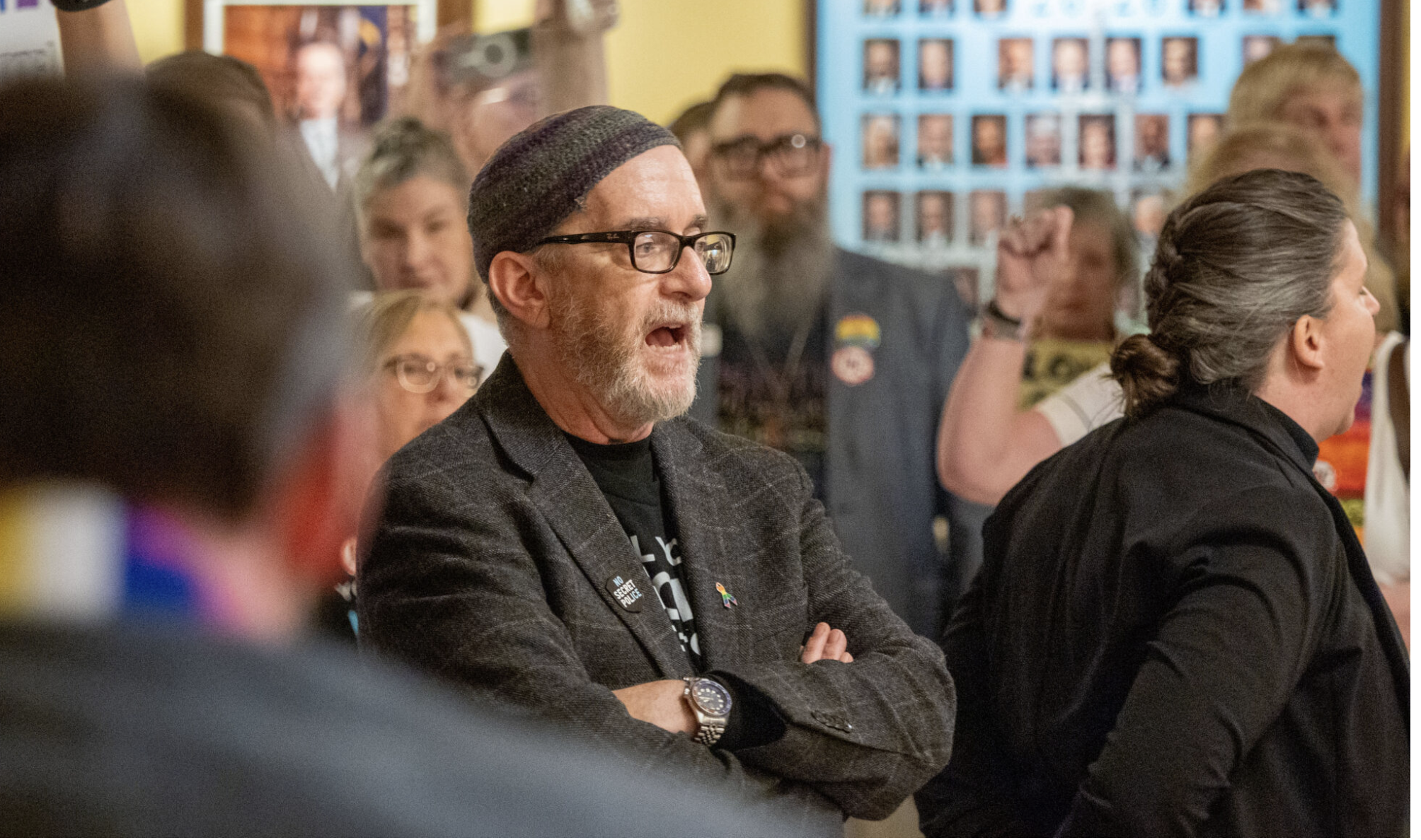 Rabbi Moti Rieber watches law enforcement as they confront protesters March 10, 2026, outside the Senate chamber in the Kansas Statehouse. (Photo by Sherman Smith/Kansas Reflector)