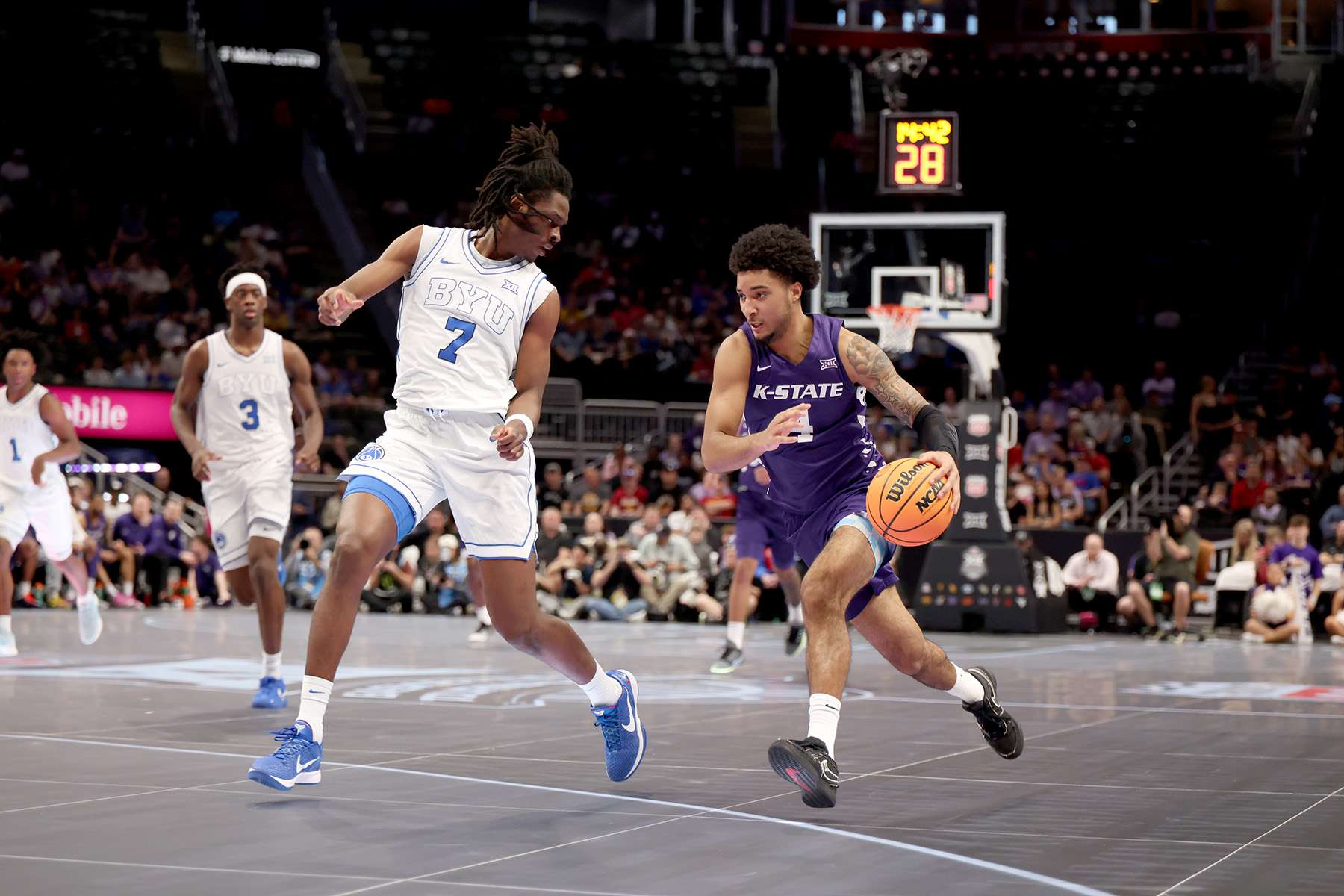 Kansas State junior P.J. Haggerty (4) dribbles the ball up the floor against BYU's Khadir Mboup (7) in the first half of their Big 12 Tournament game on Tuesday, March 10, 2026 in Kansas City, Mo. (Kansas State athletics photo)