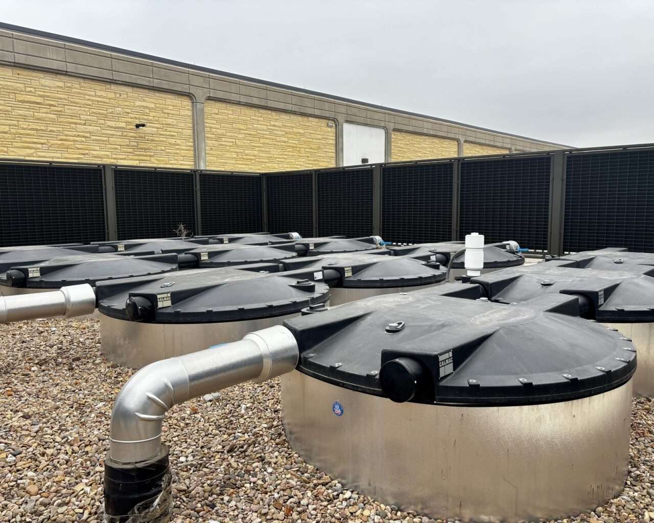 Fort Hays State University's spring 2025 commencement ceremony was the first time Gross Memorial Coliseum was air-conditioned. Twelve ice tanks are located on the southwest side of the building behind a fence. Photo by Tony Guerrero/Hays Post