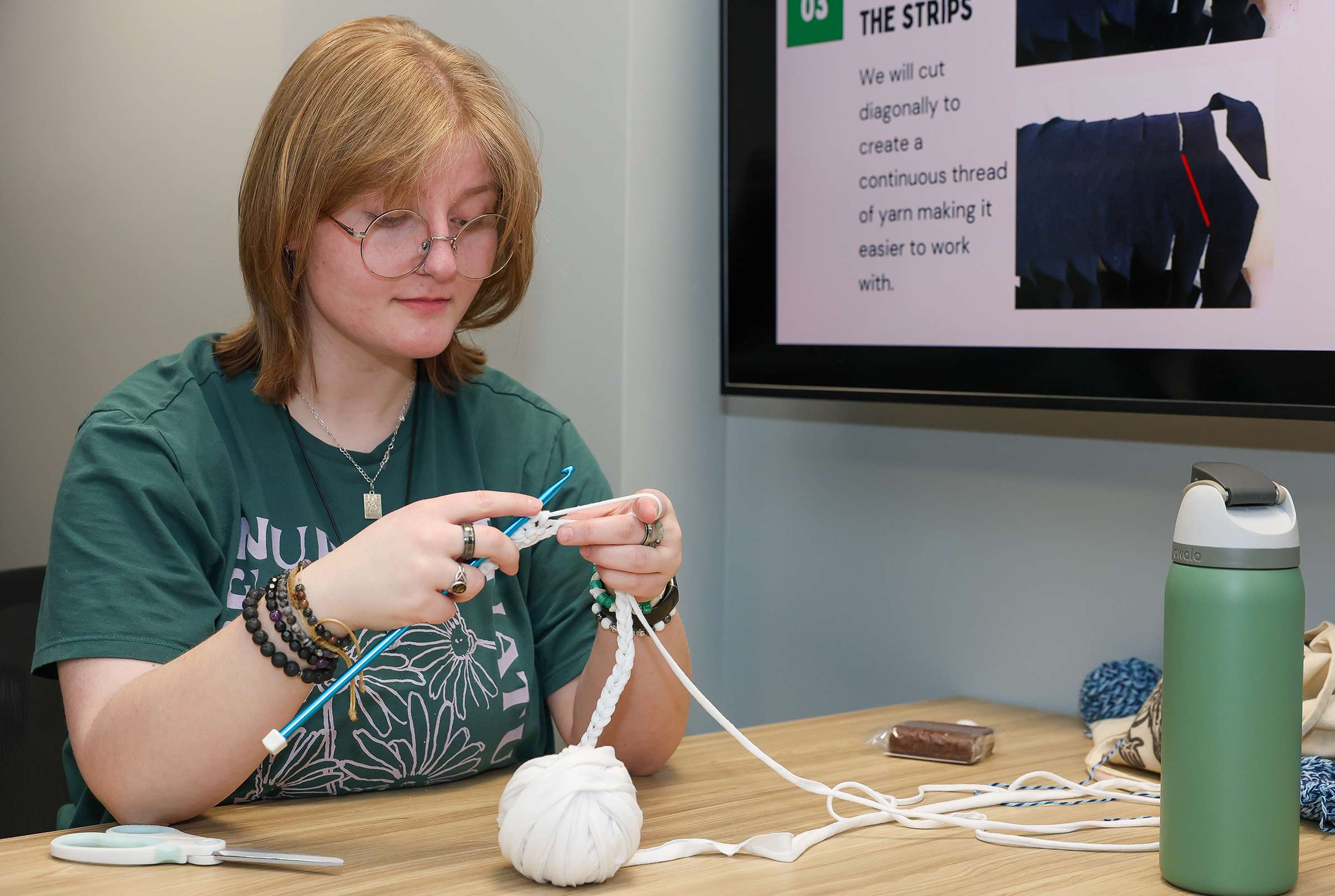 UNK junior Gabby Klein works on a project during a recent Crochet Circle meeting. She serves as vice president of the student organization. (Photo by Erika Pritchard, UNK Communications)
