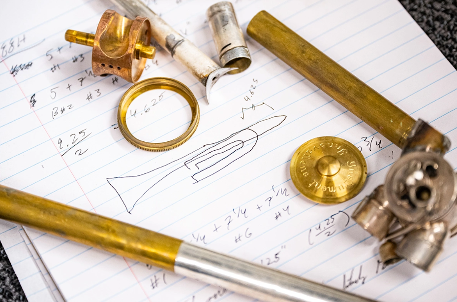 Prior to beginning restoration work, Colby Johnston — a senior in mechanical and nuclear engineering — used mathematical formulas on tube length and shape to design the parts for a "frankenstein" trombone he is repairing. (Photo courtesy K-State News and Communications)