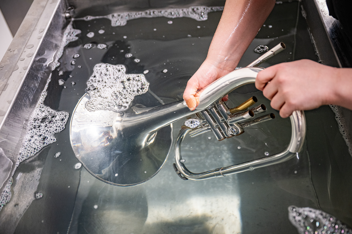 The ultrasonic cleaner tub uses sound itself to clean musical instruments. By using two contrasting sound frequencies that create vibrations at a high scale, the tub creates tiny cavitation bubbles that help knock particles off, cleaning and sterilizing instruments in the process. (Photo courtesy K-State News and Communications)