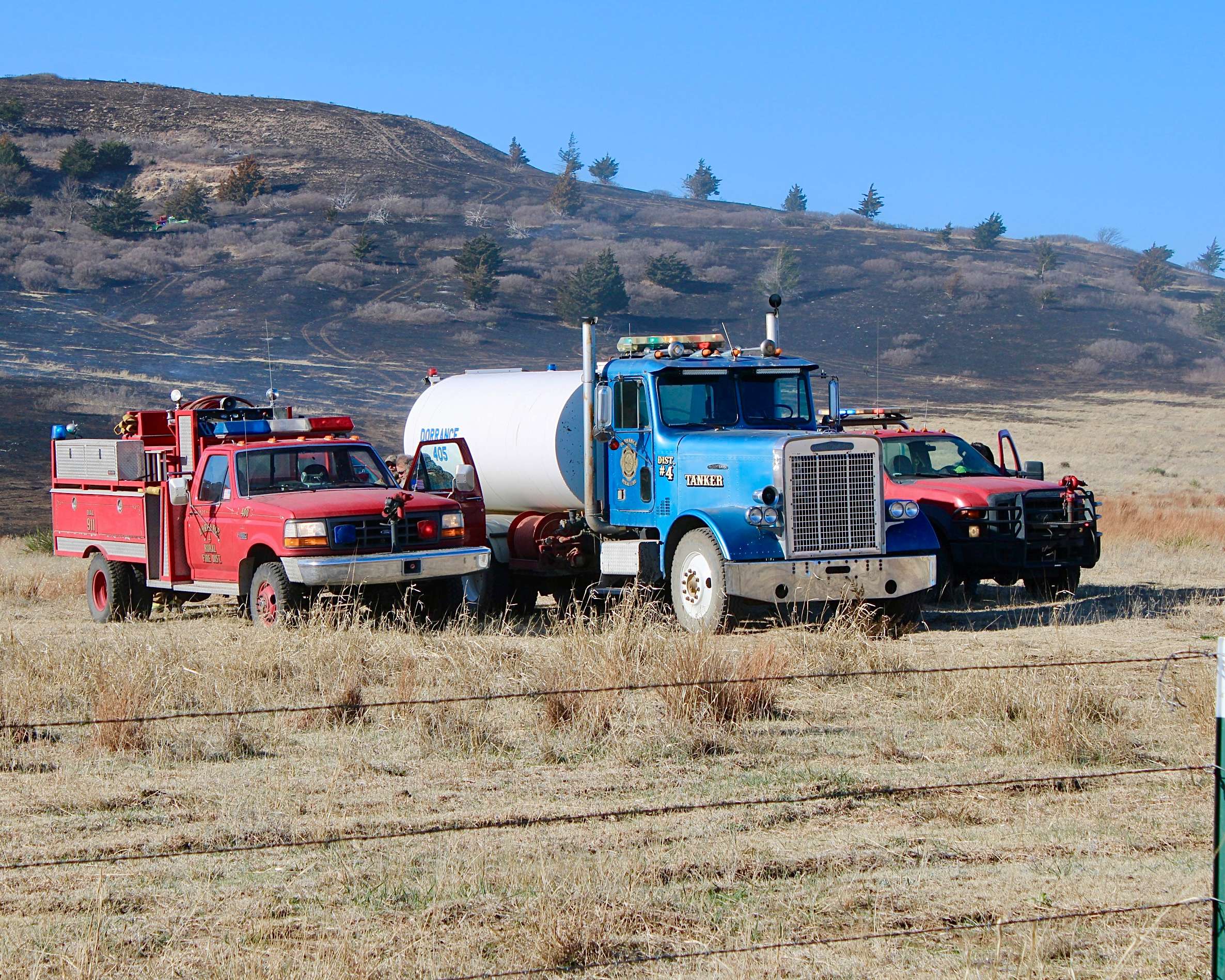 Two fire trucks and a water tanker from Dorrance responding to a fire south of Wilson Lake in Russell County. Photo by Tony Guerrero/Hays Post