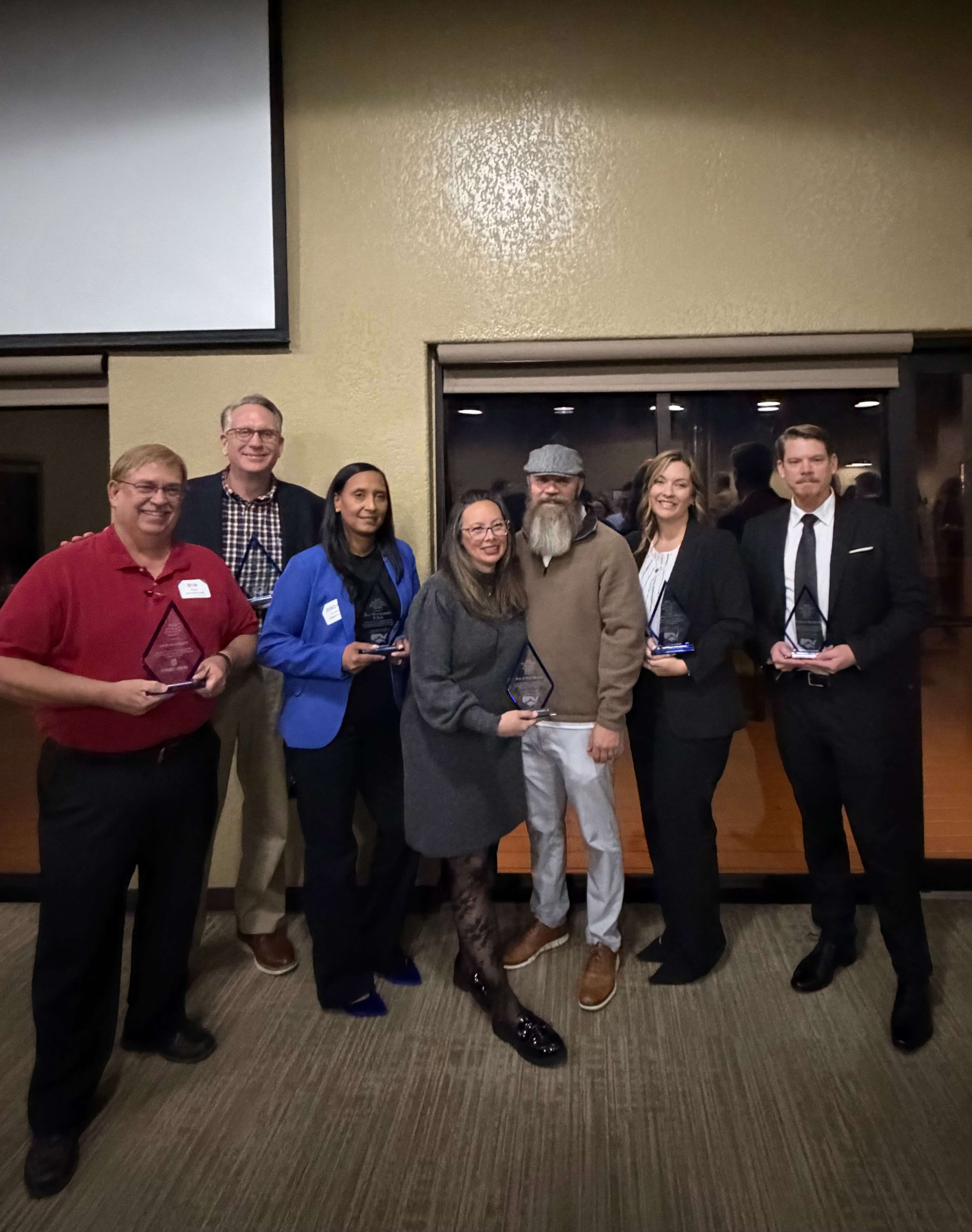 Chamber of Commerce 2026 award winners - Pictured left to right - Bob Story (Freedom Fest, Tourism Advocate Award), Ron Johnson (Outstanding Citizen Award), Jordan Yohannes (Blu Restaurant and Bar, Business Excellence Award), Nina and Rob Wilson (Military Affairs Council, Seitz Military Award), Tracy Duran (Stormont Vail Health, Flint Hills Campus, EDC Award), Josh Sandlin (Society of 1st Infantry Division,&nbsp;Seitz Military Award).