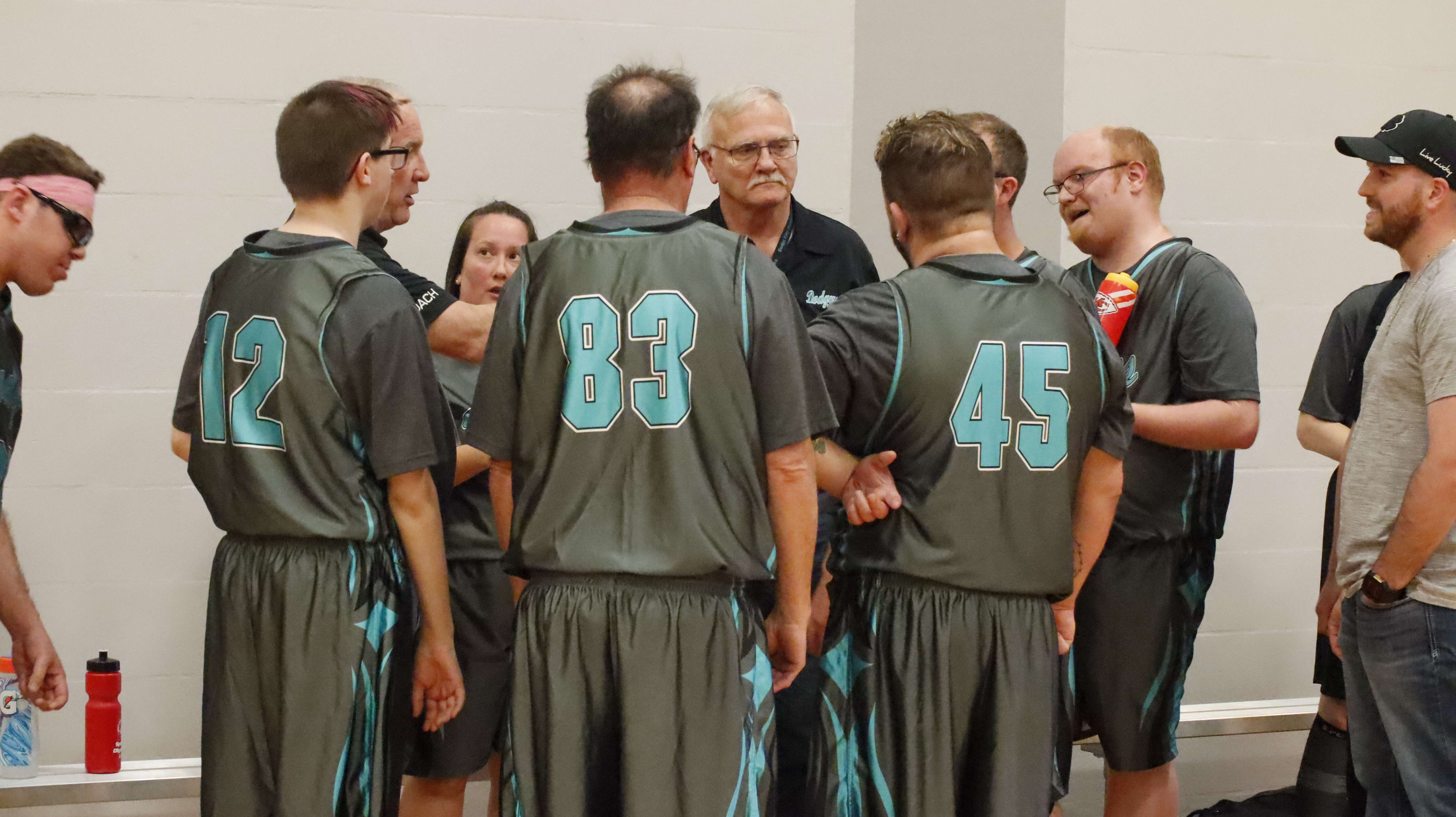 A team of basketball players huddled together at the 2025 basketball tournament. Photo courtesy of Special Olympics Kansas