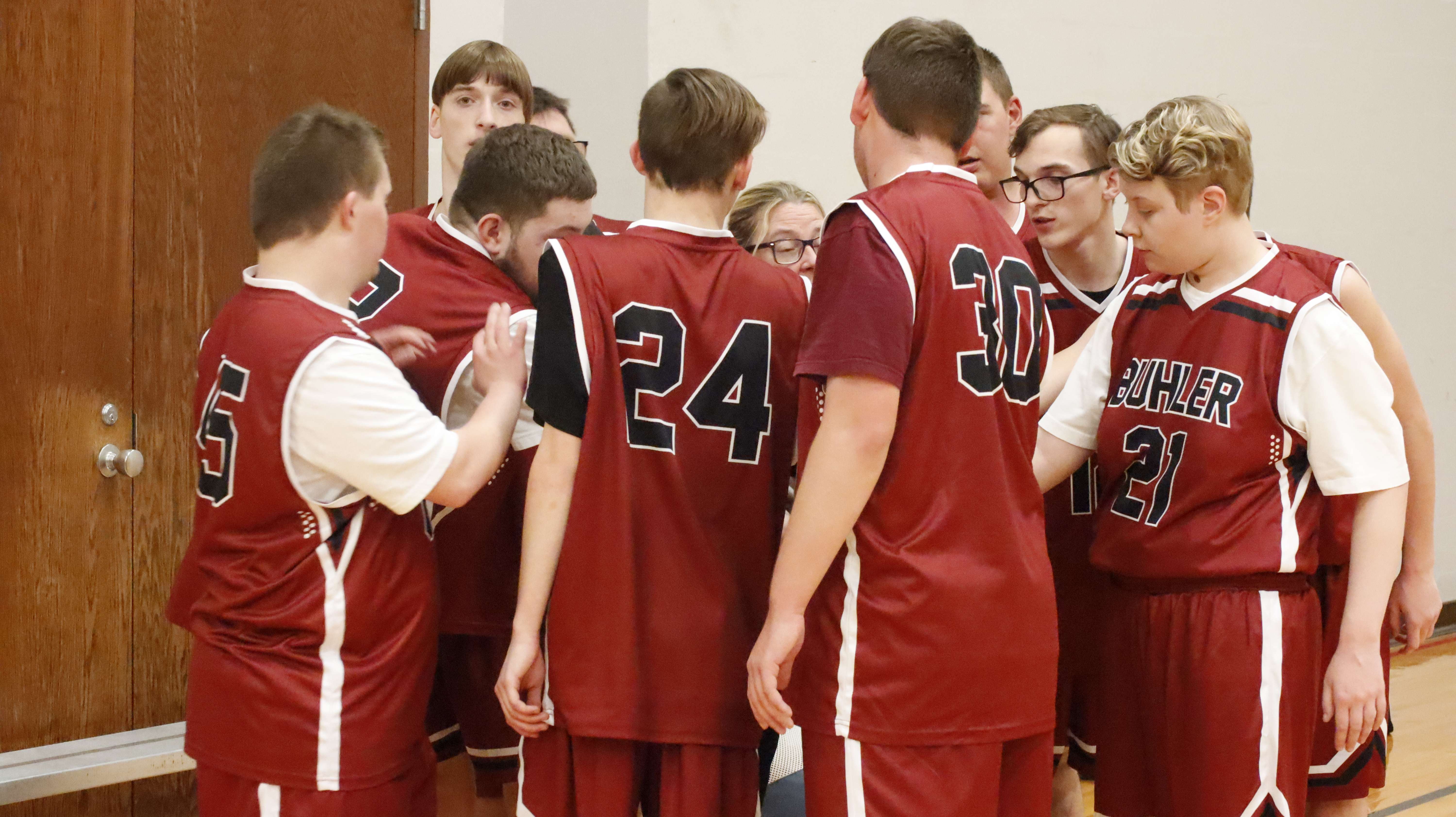 A team of basketball players huddled together at the 2025 basketball tournament. Photo courtesy of Special Olympics Kansas