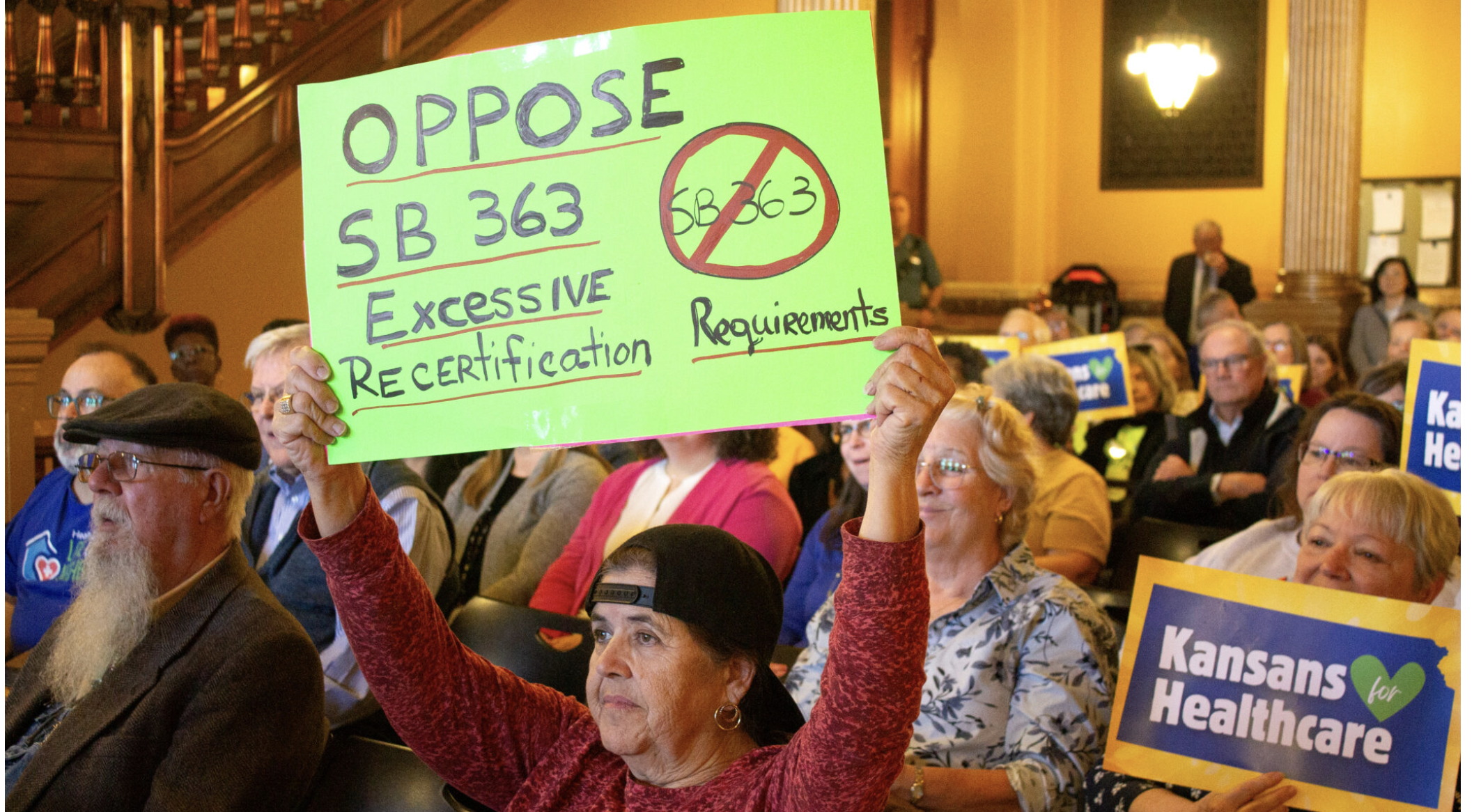  Kansans rallied against Senate Bill 363, which would force Kansans to recertify their eligibility for public assistance programs every quarter March 12, in the Statehouse. (Photo by Grace Hills for Kansas Reflector)