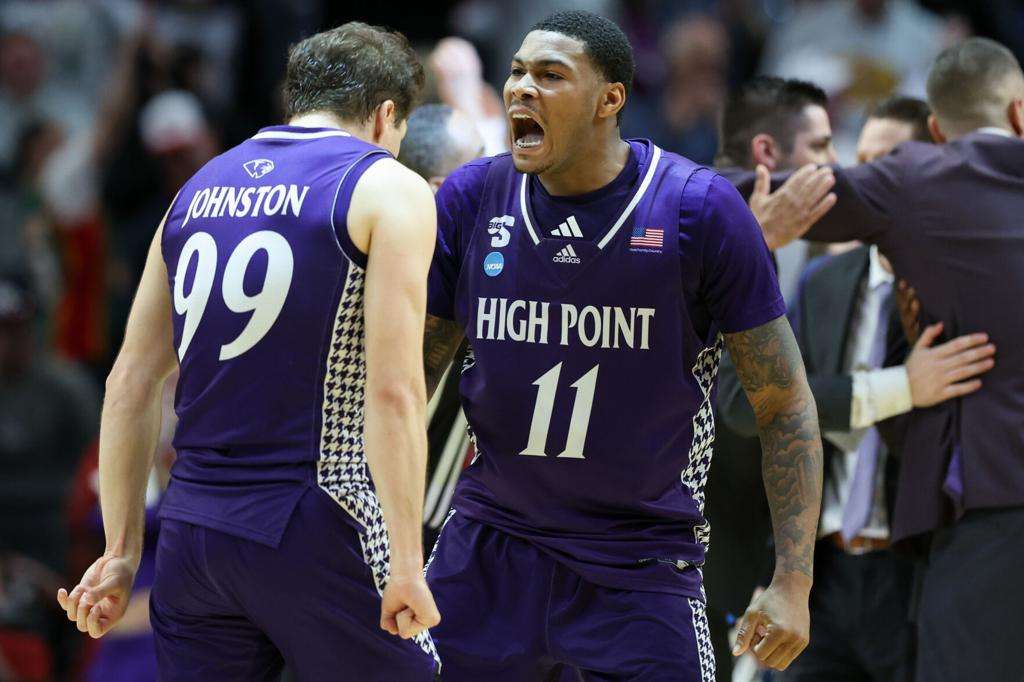 High Point forward Cam'ron Fletcher (11) celebrates with guard Chase Johnston (99) during the second half in the first round of the NCAA college basketball tournament against Wisconsin, Thursday, March 19, 2026, in Portland, Ore. (AP Photo/Amanda Loman)