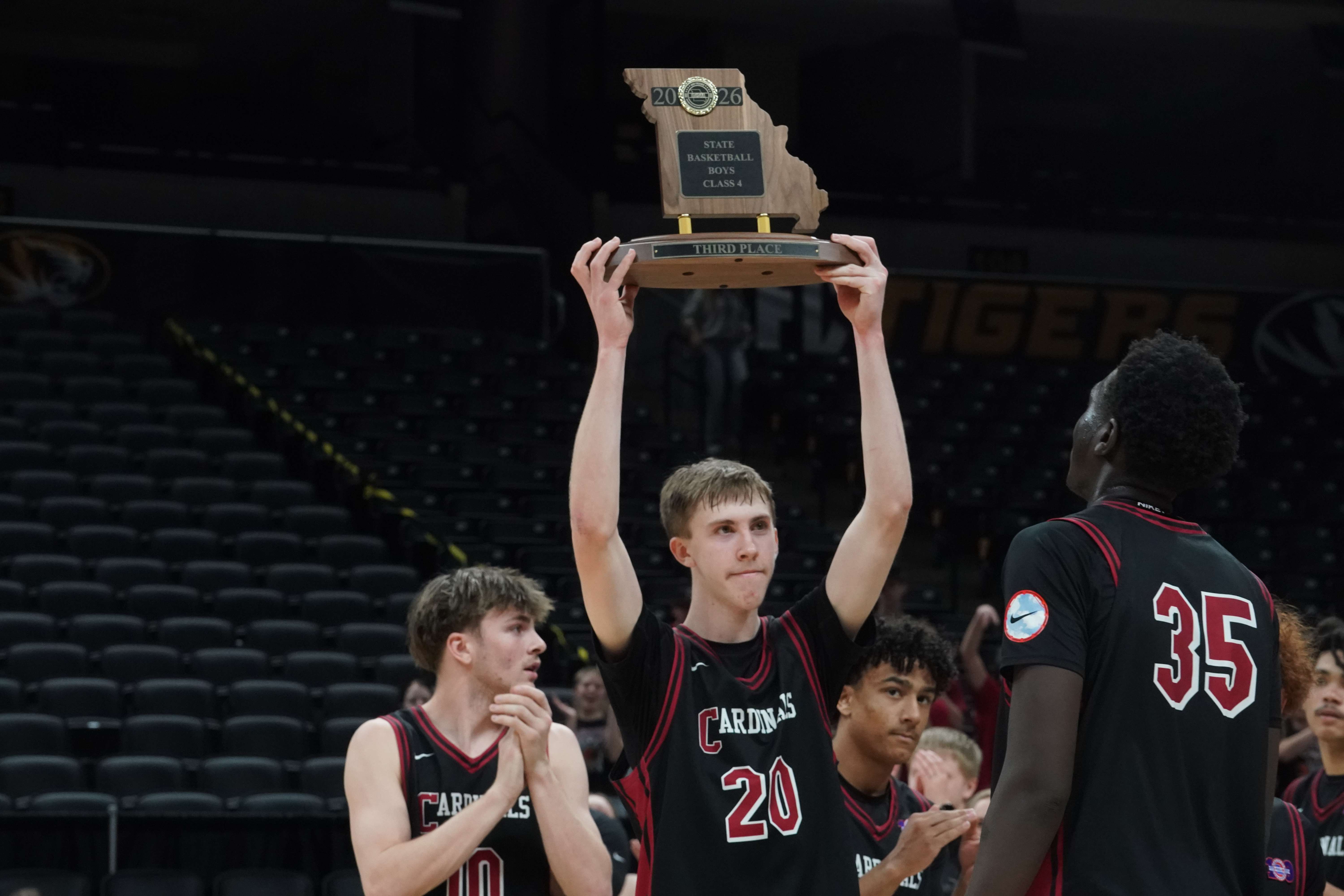 Benton senior Lincoln Goodwin hoists the third place trophy after the Cardinals defeated Vashon 84-81 in overtime in the MSHSAA Class 4 Third Place game/ Photo courtesy of Clifton Grooms
