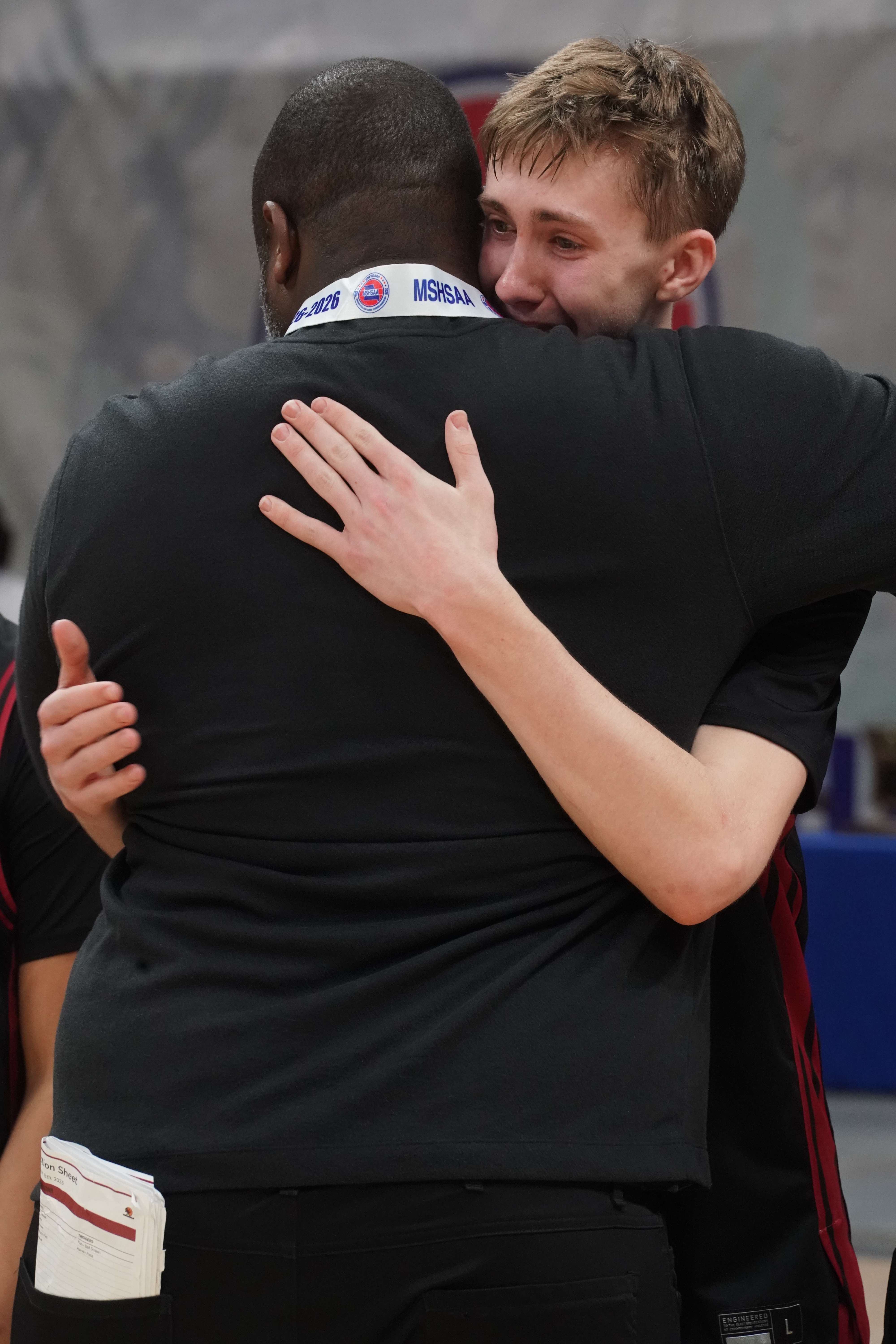 Lincoln Goodwin and head coach Jared Boone embrace following the Benton Cardinals 84-81 win in the MSHSAA Class 4 Third Place game/ Photo courtesy of Clifton Grooms