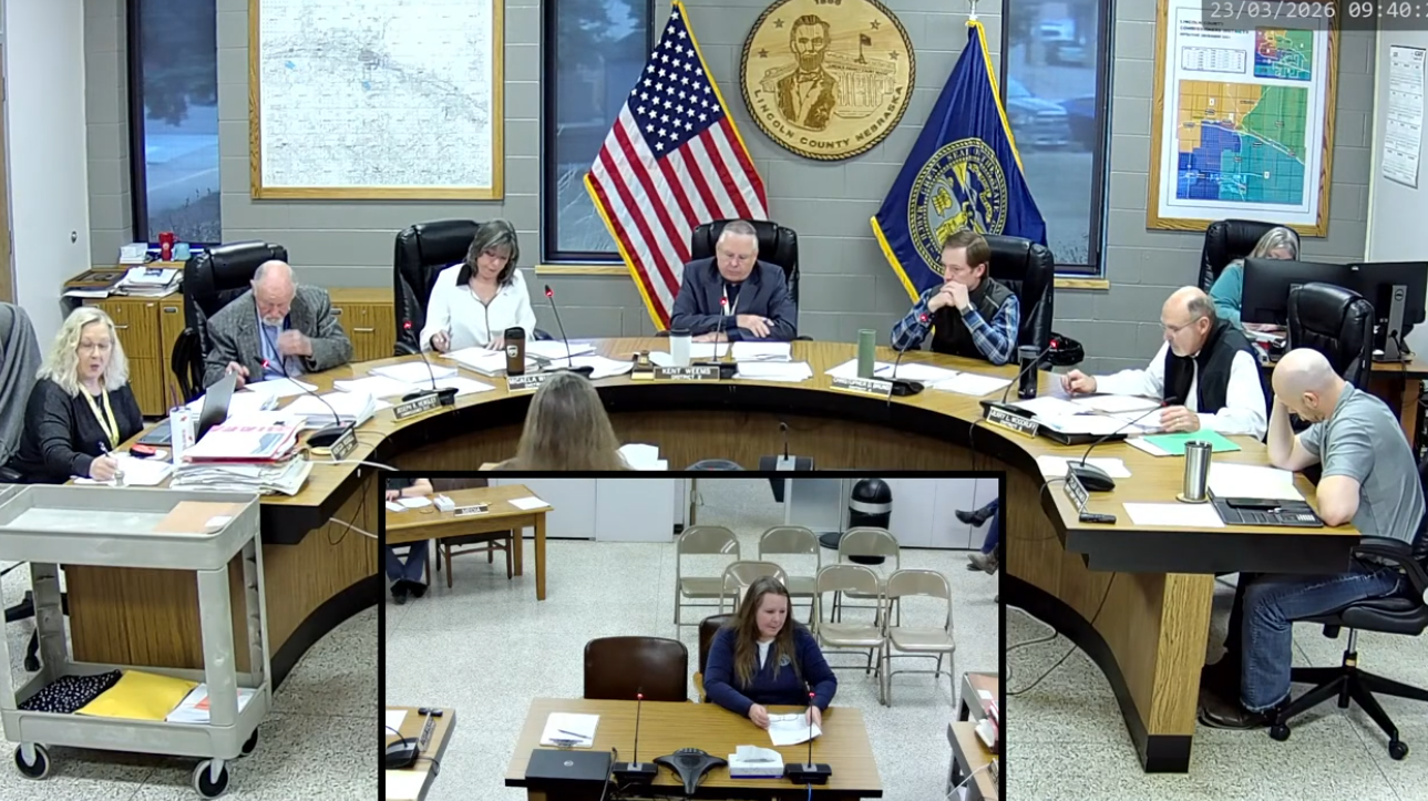 Lincoln County Commissioners meet March 23, 2026, in North Platte, with Planning and Zoning Administrator Judy Clark (center screen inset) addressing the board. Clark outlined a proposal to waive land-use permit fees for residents rebuilding after the recent Cottonwood Fire, saying the goal is to “make it a little bit easier” for those impacted. Commissioners later unanimously approved the measure, calling it a small but meaningful step to help families recover.