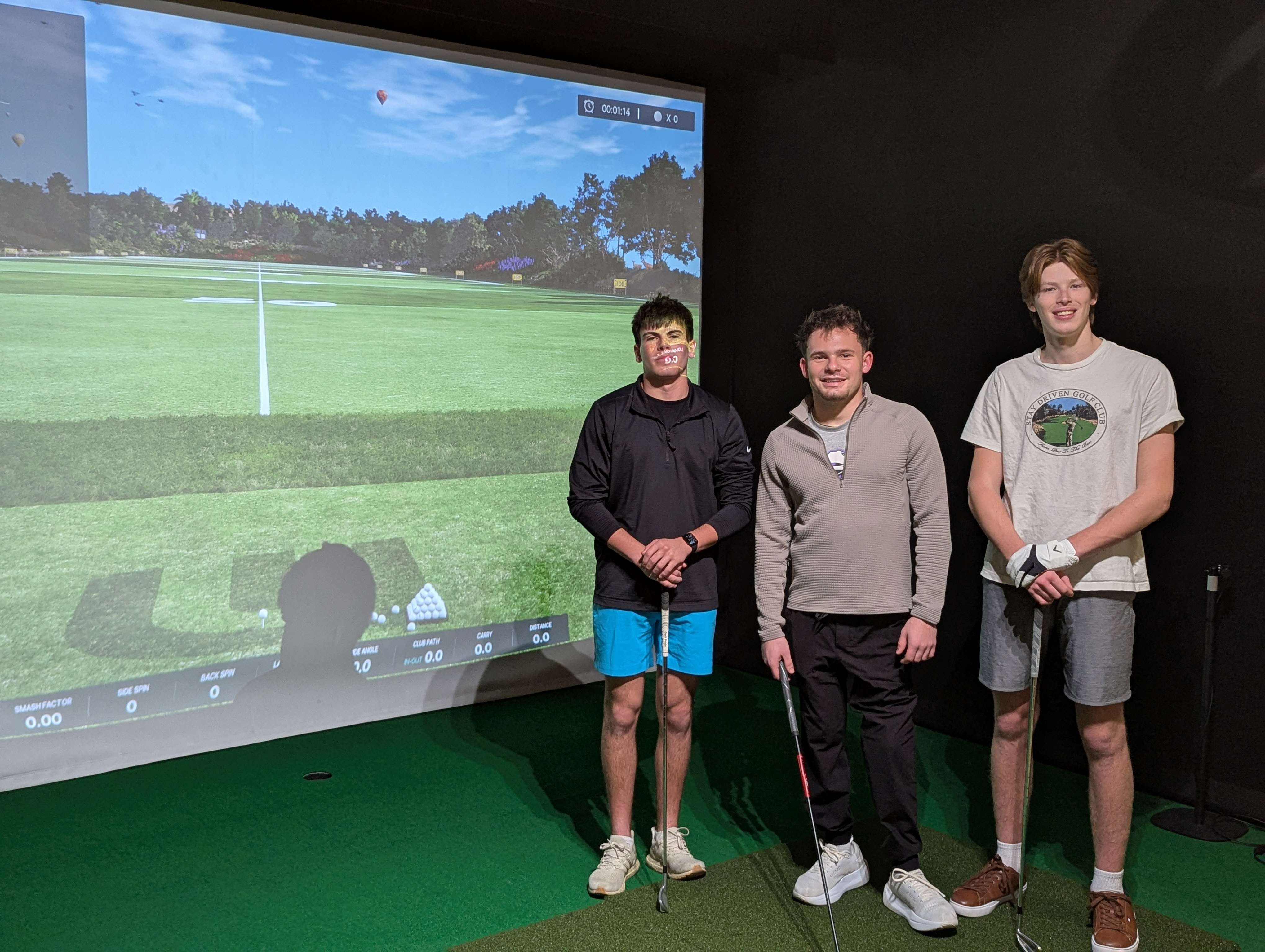Thanks to community generosity, GBHS seniors Ethan Somers, Nash Lindberg, and Zachary Hart stand in one of the new golf simulator bays recently installed inside the Panther Fieldhouse.