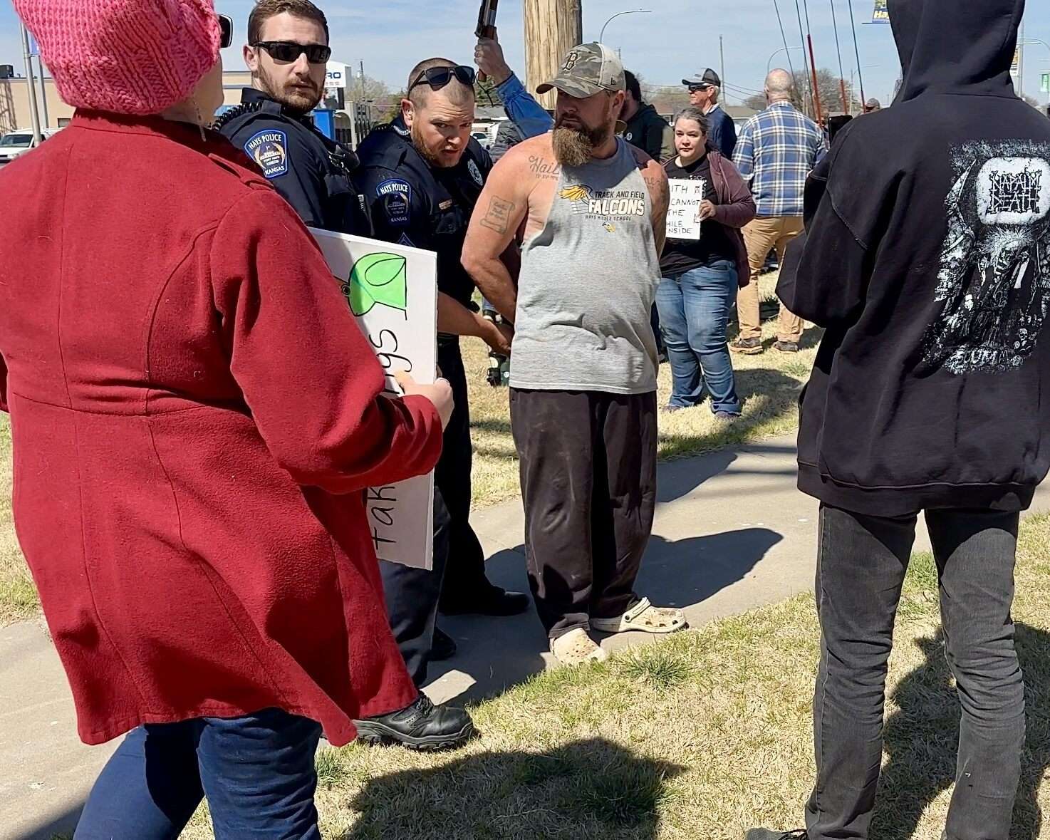 The unknown man being detained by officers on the corner of 27th and Vine streets in Hays. Photo by Tony Guerrero/Hays Post