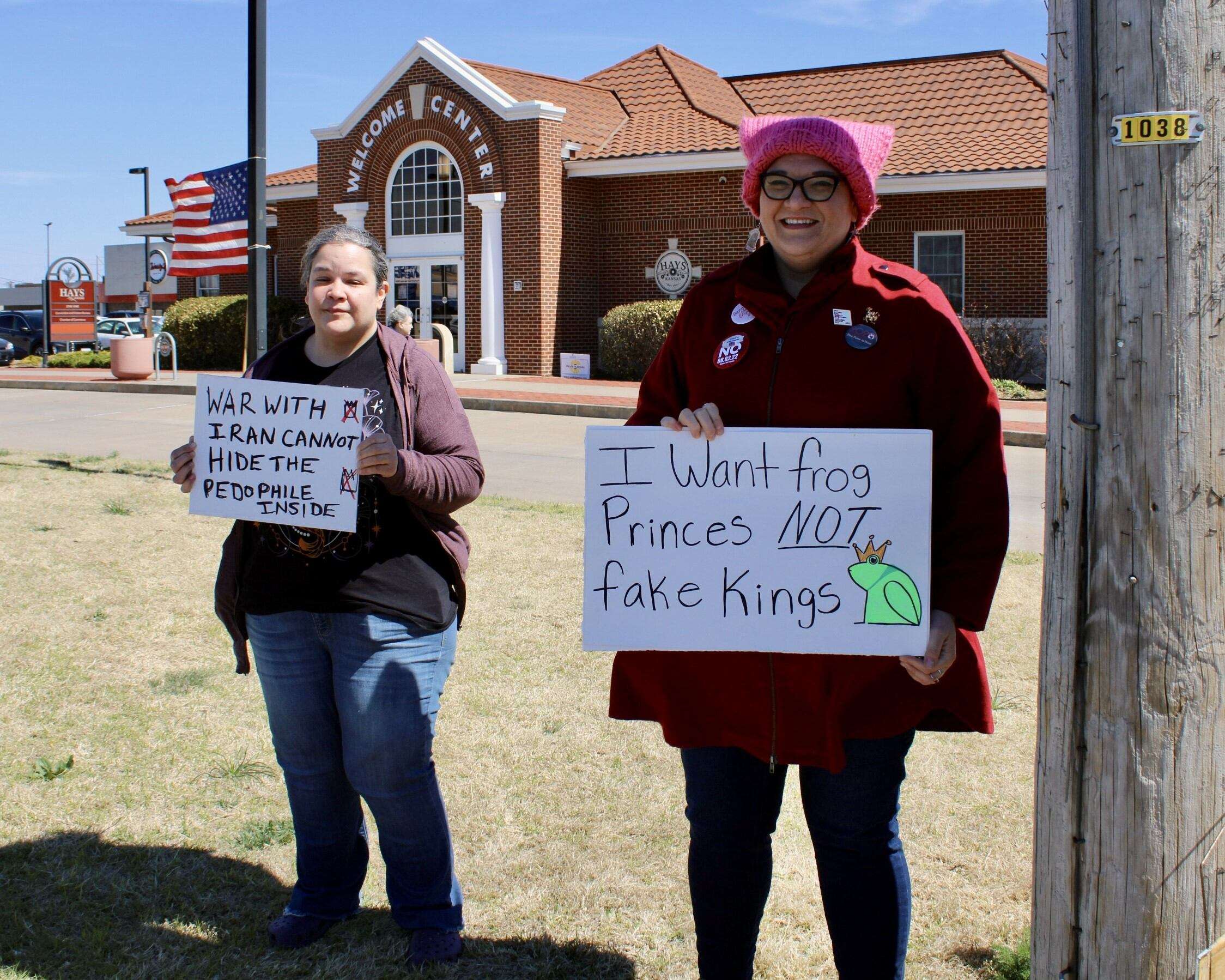 Anna Towns (right), chairwoman of the&nbsp;Ellis County Democratic Party, with a sign at Saturday's protest on the corner&nbsp;of 27th and Vine streets in Hays. Photo by Tony Guerrero/Hays Post