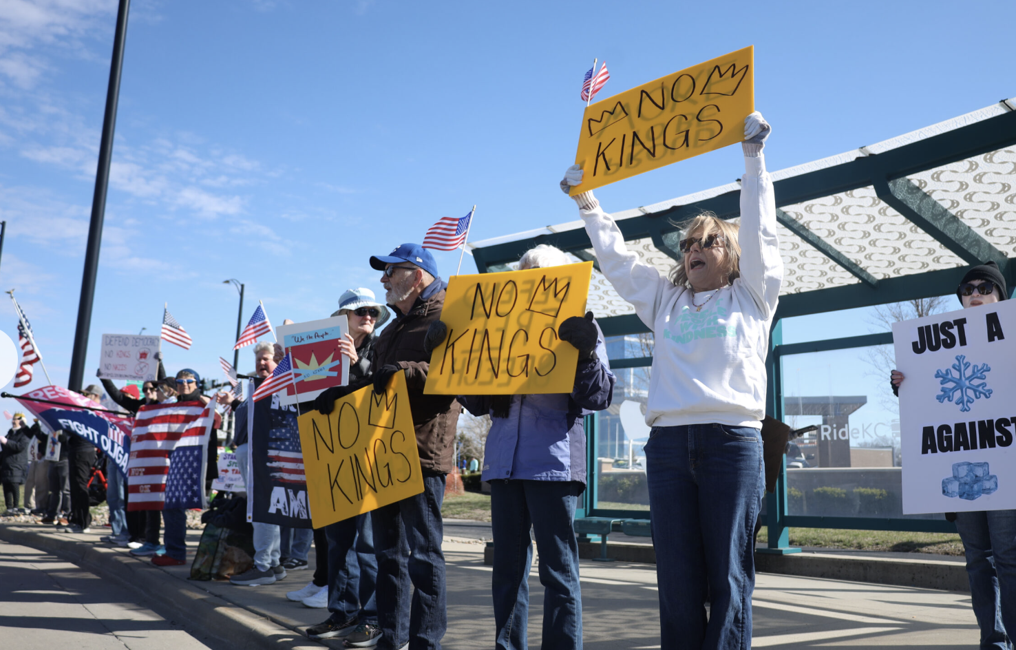 Protestors line up March 28, 2026, along a six-mile stretch of Metcalf Avenue as part of a No Kings rally in Johnson County. (Photo by Maya Smith for Kansas Reflector)