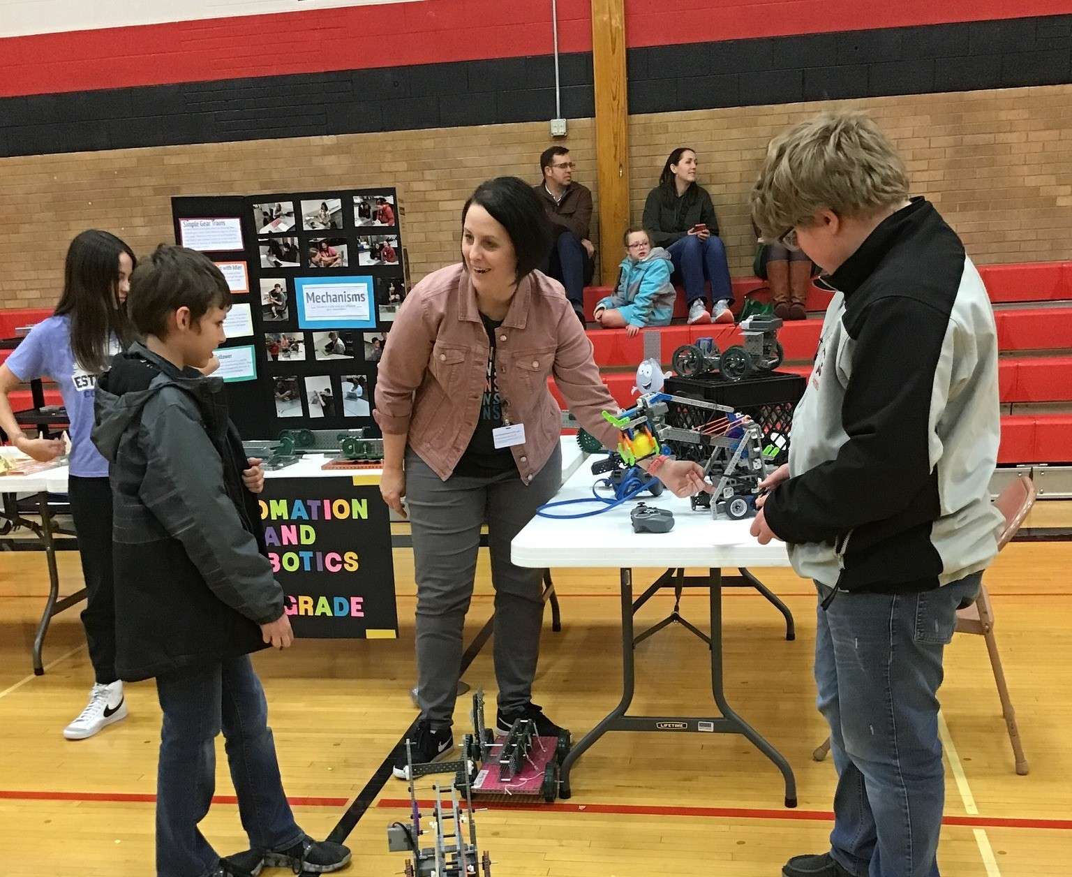 Amy Stein, GBMS Robotics Teacher, visits with students during a previous Spring Expo, highlighting the hands-on learning and innovation that make the event a showcase of student achievement.