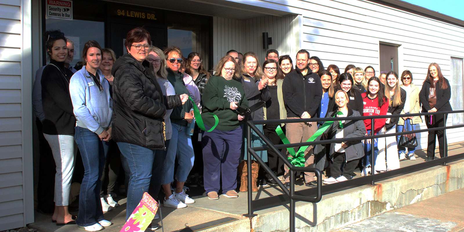 On Friday, the staff and guests cut a ribbon to celebrate the 60th anniversary of the Hays Area Children Center. Photo by Cristina Janney/Hays Post
