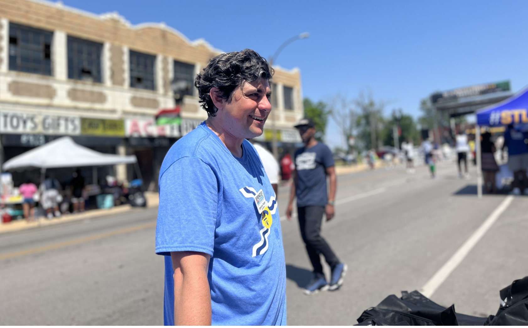 Spencer Toder, during his 2020 run for U.S. Senate seat, speaks with residents at the Black Wall Street 314 Festival in Wellston Loop in St. Louis (Tessa Weinberg/Missouri Independent).