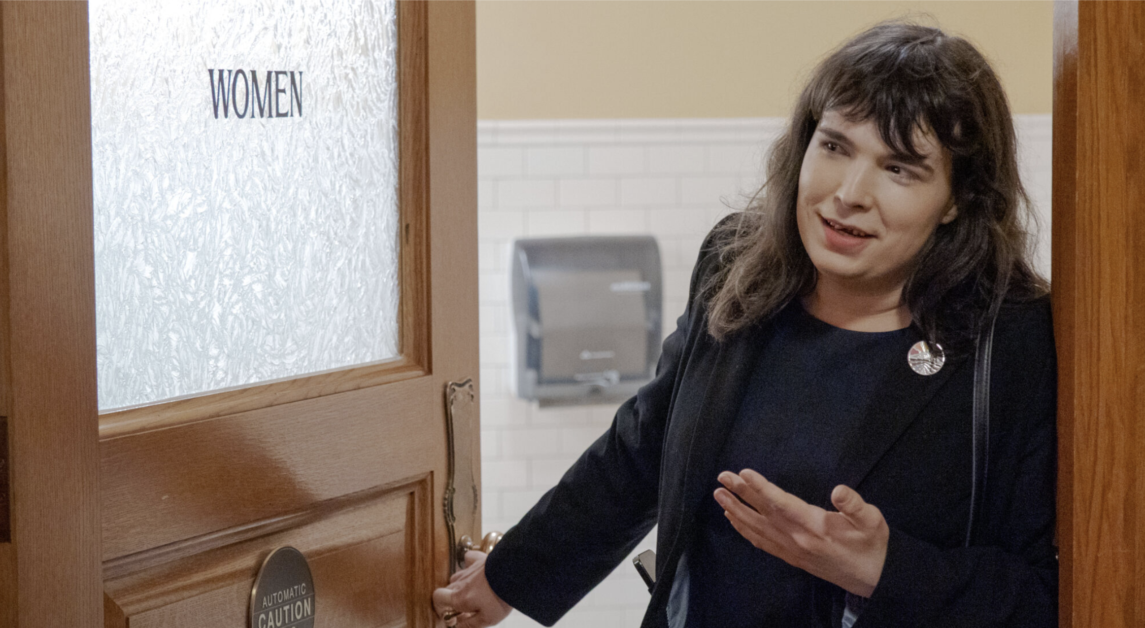 Samantha Boucher, founder and executive director of Trans Liberty, uses a second floor women’s restroom on March 31, 2026, as part of a Trans Day of Visibility demonstration at the Kansas Statehouse. (Photo by Sherman Smith/Kansas Reflector)