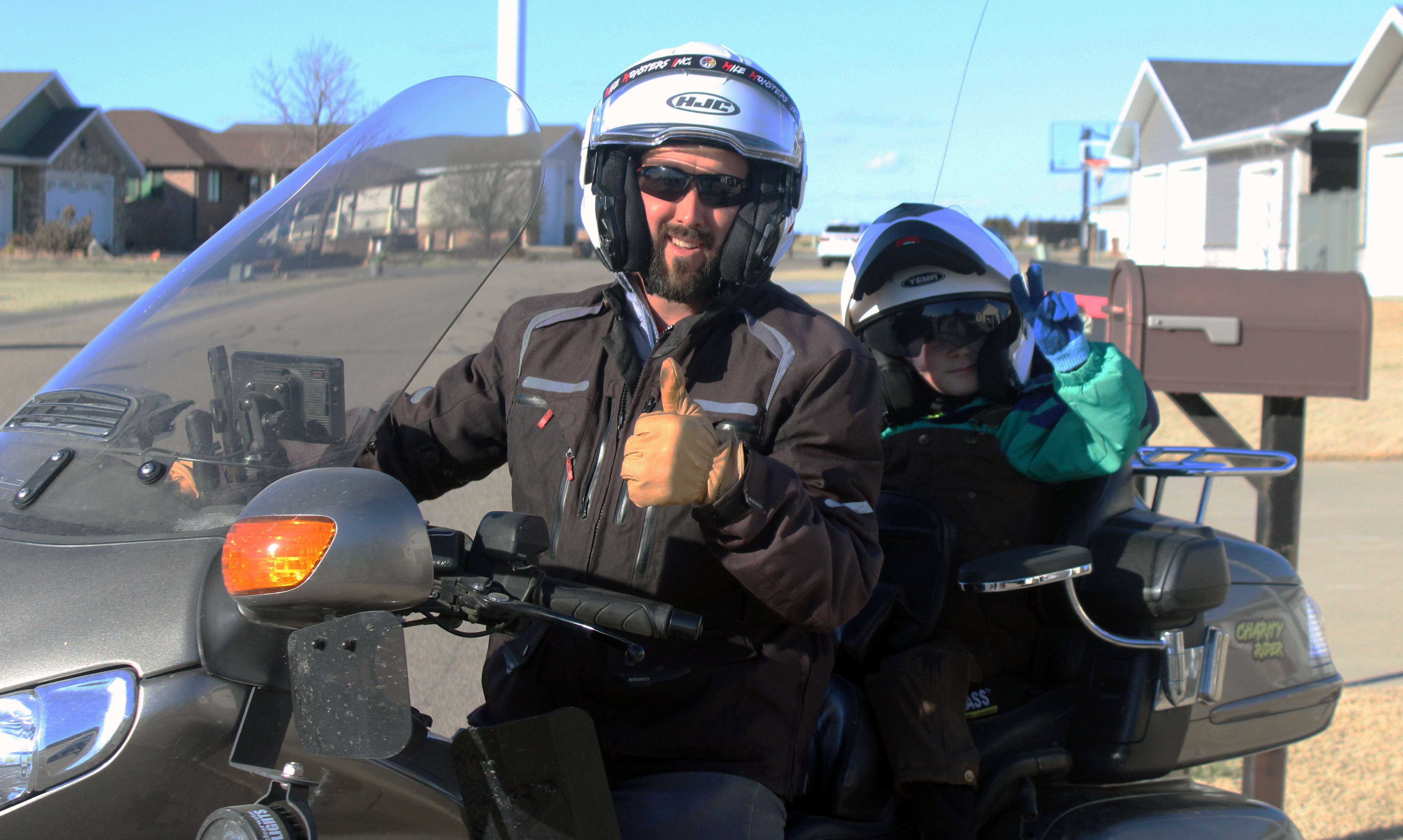 Jon Dooley of Hays and Brody Kough of Victoria on Dooley's Honda Golden Wing. Dooley is walking seven miles every day for a year to raise money for seven boys with&nbsp;Duchenne muscular dystrophy, including Brody. Photo by Cristina Janney/Hays Post