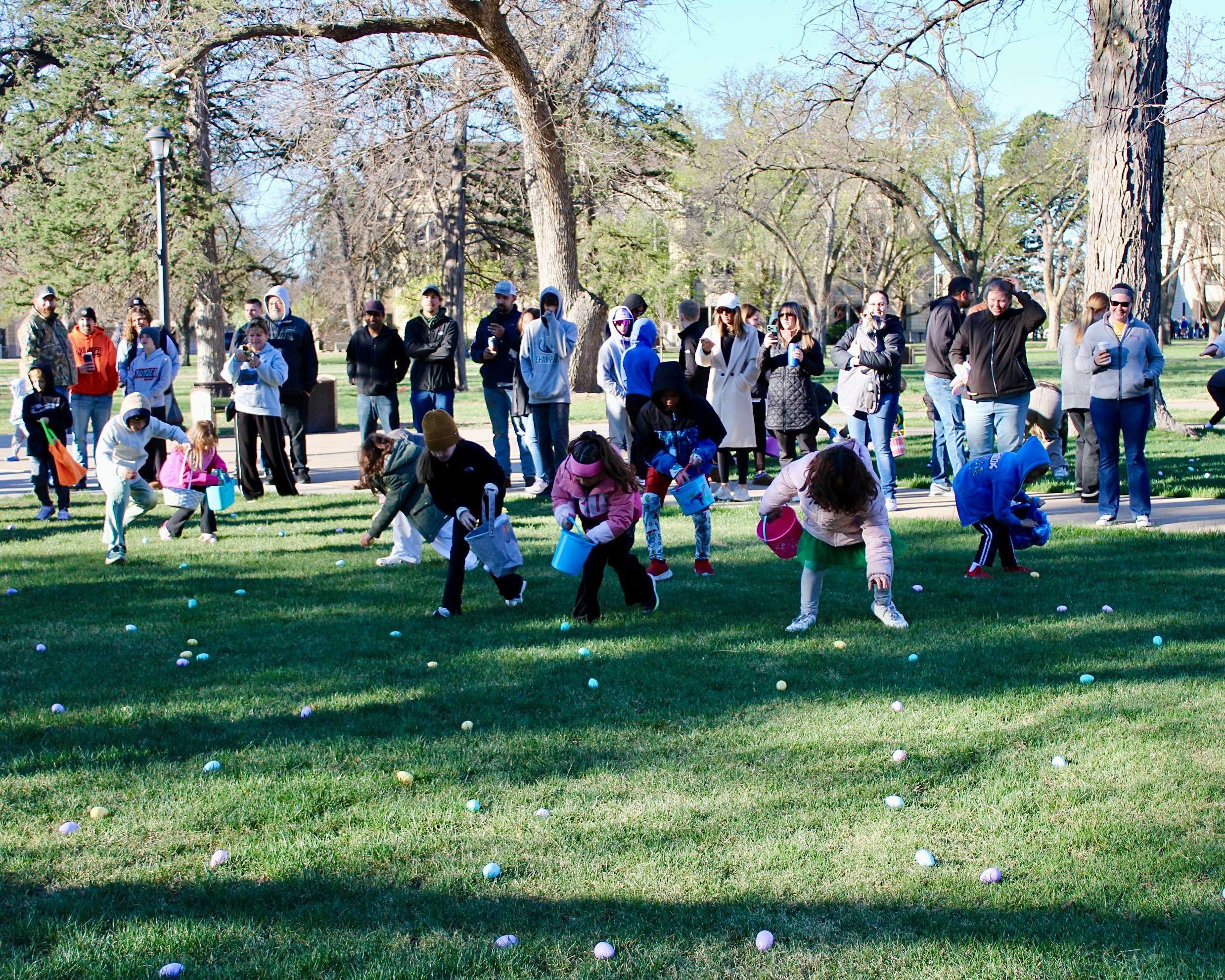 Children picking up eggs at the Hays Kiwanis Club 52nd annual Easter egg hunt on Saturday. Photo by Tony Guerrero/Hays Post