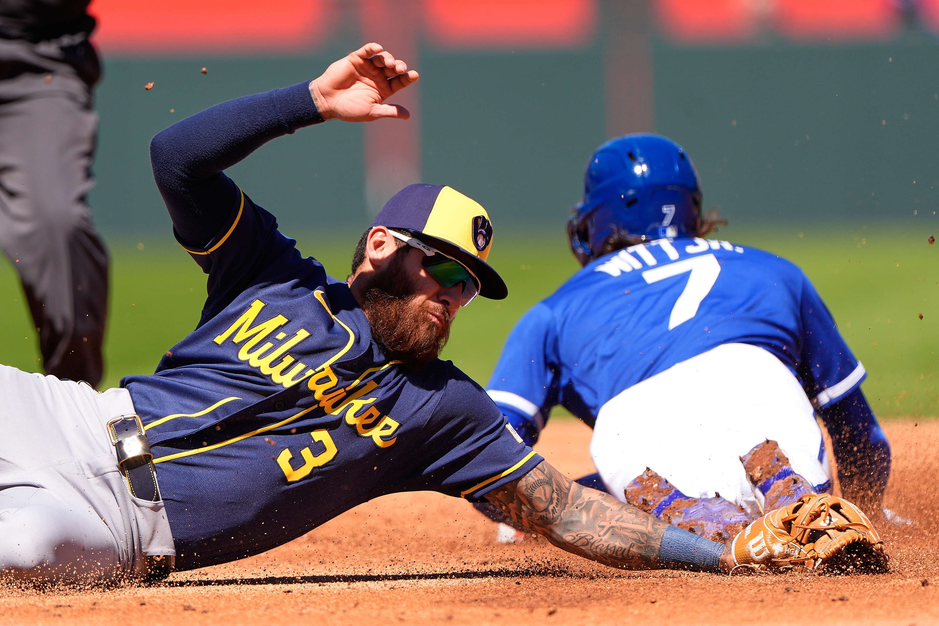 Kansas City Royals' Bobby Witt Jr. (7) beats the tag by Milwaukee Brewers shortstop Joey Ortiz to steal second during the third inning of a baseball game Sunday, April 5, 2026, in Kansas City, Mo. (AP Photo/Charlie Riedel)