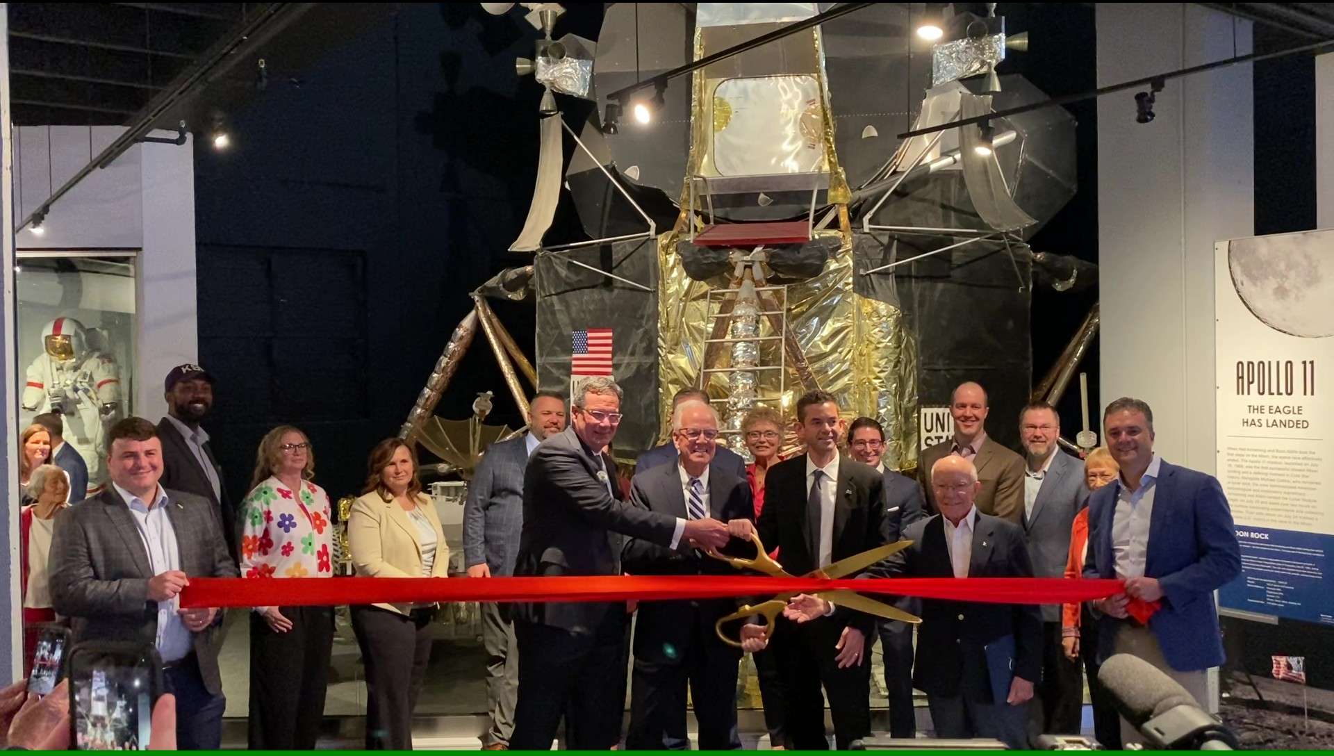 Flanked by Cosmosphere Board members, CEO Jim Remar and Senator Jerry Moran prepare to cut the ribbon to mark the official reopening of the Hall of Space Museum at the Cosmosphere (Hutch Post photo)